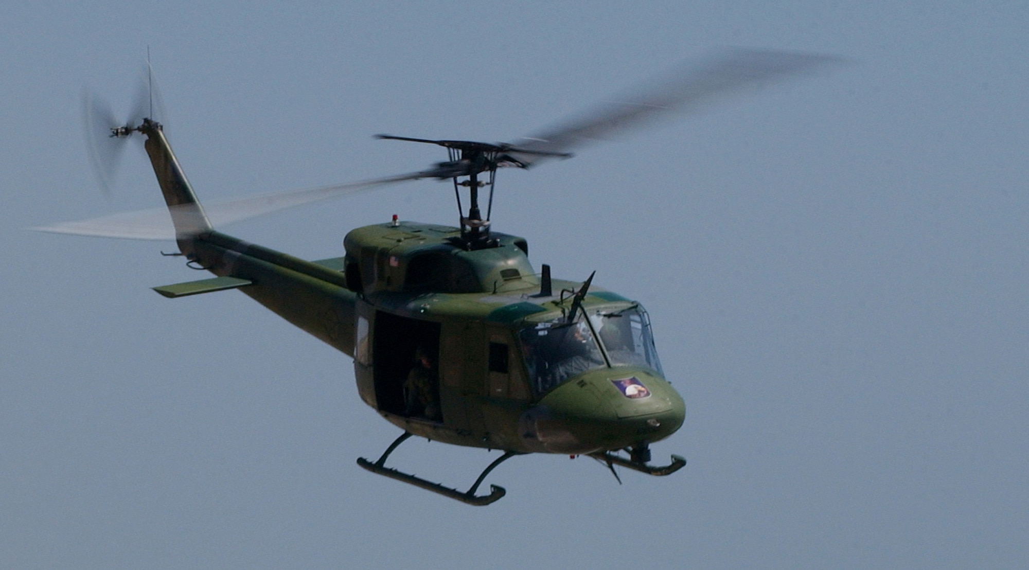 Huey soars above the cloudy skies of Vandenberg on a training mission.