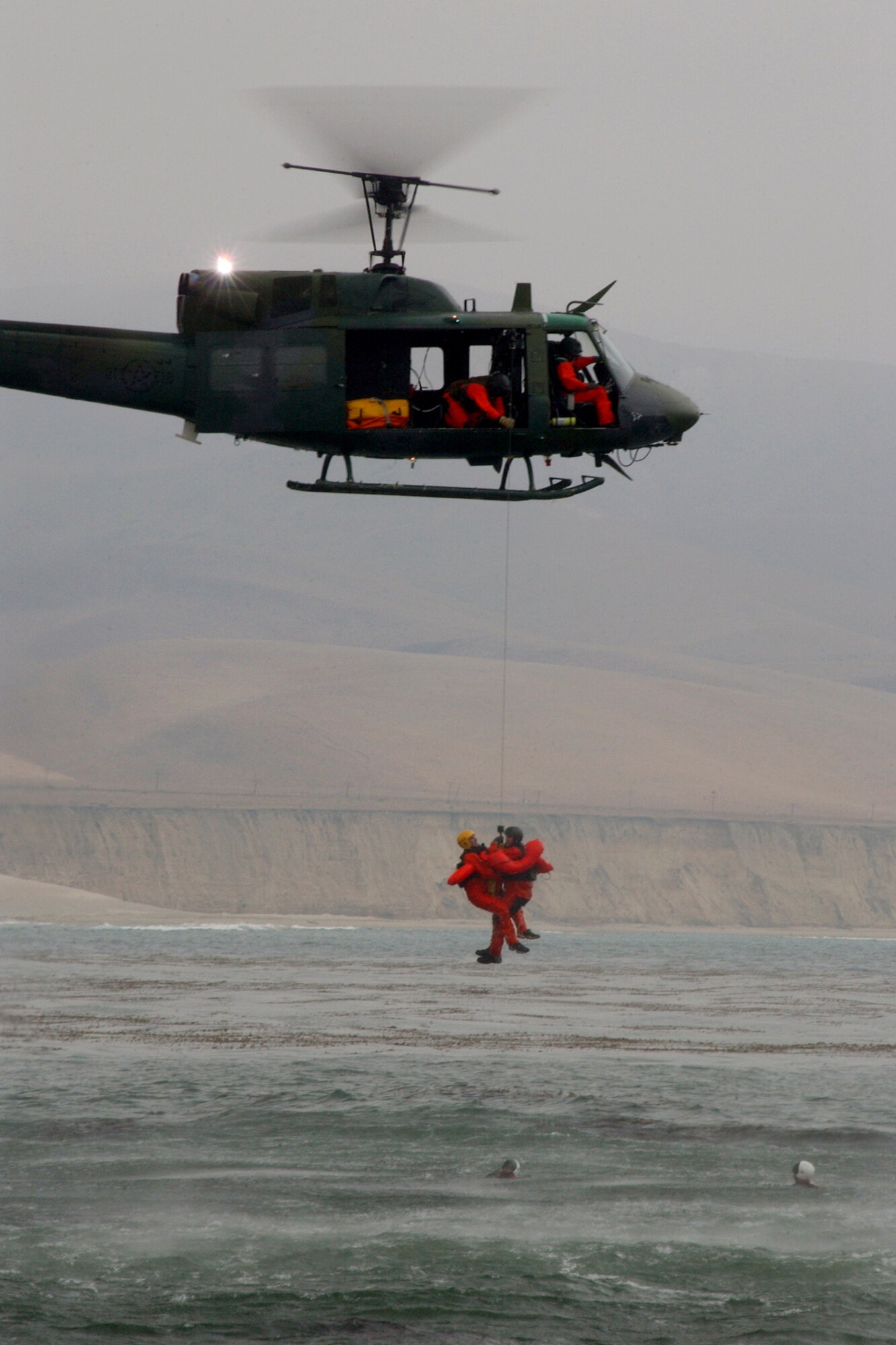 A crew from the 76th Helicopter Flight train using practices rescue techniques off the central coast of California. The 76th HF provides fire suppression post-launch disaster control and local wildland vegetation management.