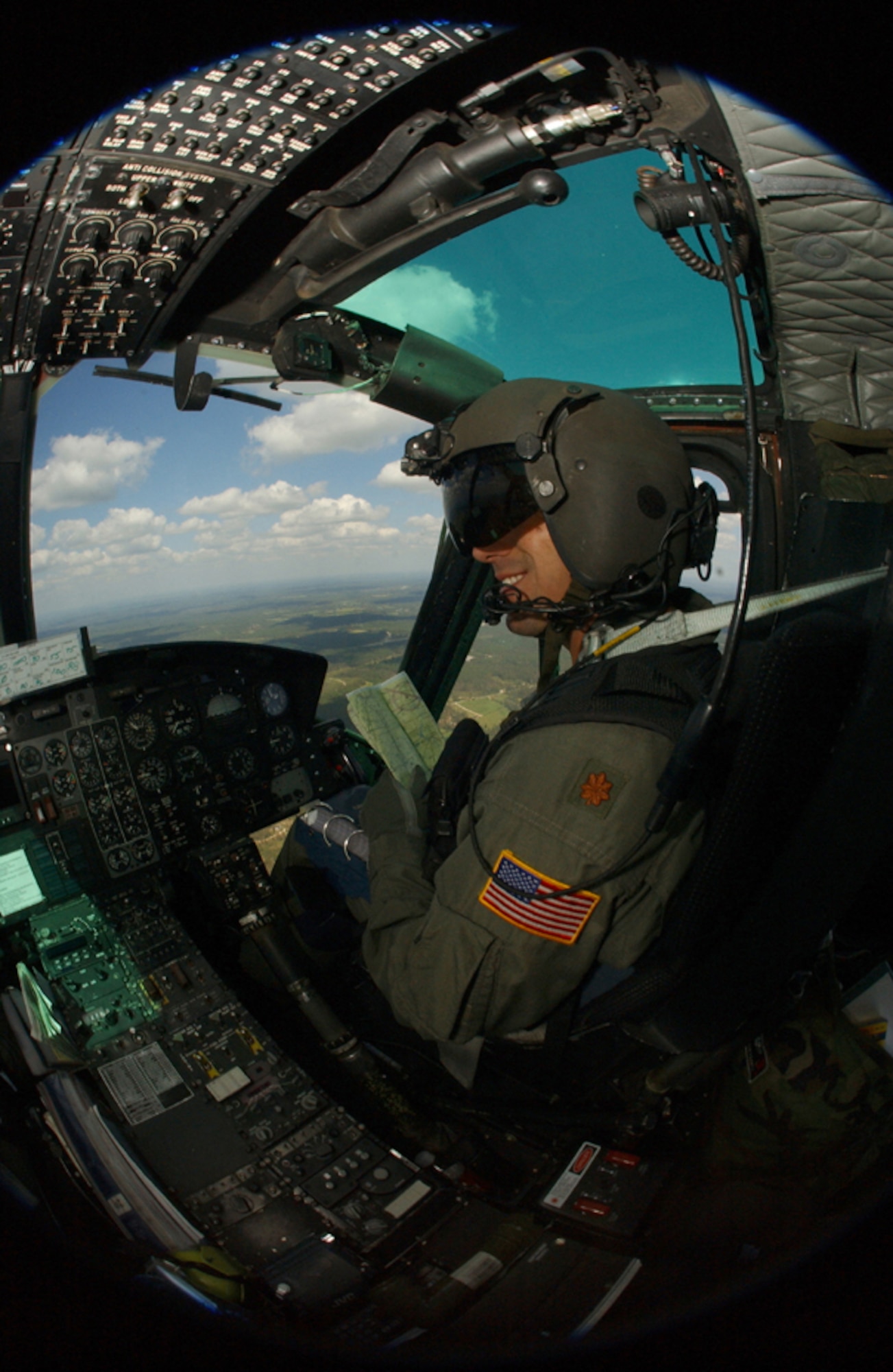 Major Ronald Frantz, Commander of the 76th Helicopter Squadron here, surverys the ground as he flys over Vandenberg. More than 60 percent 76th HS 1273 flying hours are spent training in a year.