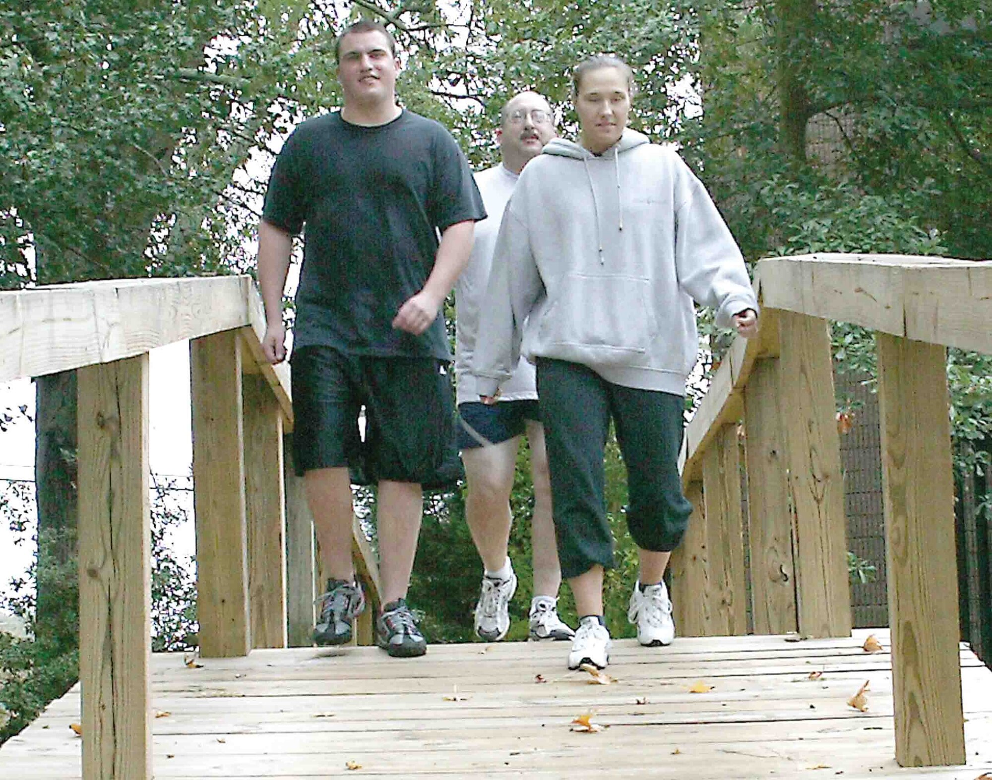 Senior Airman Ryan Markich (left), 20th Equipment Maintenance Squadron, Chief Master Sgt. Don DeMarte (center), 20th Maintenance Operations Squadron, and Staff Sgt. Samantha Brown, 20th Services Squadron, go for a walk at the Chapel Trail Tuesday in participation of the Health and Wellness Center?s Walk-a-thon. October is national walking month. (U.S. Air Force photo/Tarsha Storey)