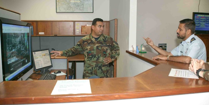 SHAW AIR FORCE BASE, S.C.-- Tech. Sgt. Amado Azua (left), 20th Operational Support Squadron, trains Pakistani Air Force Maj. Muhammad Rehan Ashraf Oct. 12 how to provide weather support to combat weather teams. Maj. Ashraf was selected to be a weather squadron commander in Pakistan and is sponsored by the U.S. Air Force to obtain meteorological training from Shaw and Keesler Air Force Base, Miss. (U.S. Air Force photo/Senior Airman John Gordinier) 

