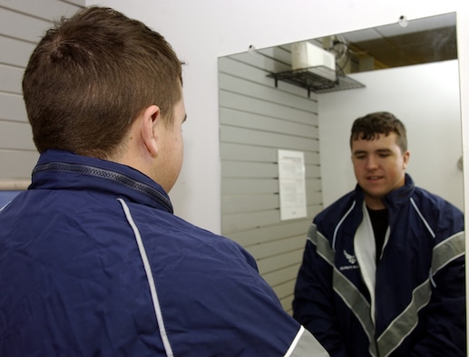 Airman 1st Class Nathaniel Prost, 30th Space Communications Squadron, inspects
the fit of the new Air Force PT uniform at Vandenberg Military Clothing Sales. The
uniform becomes mandatory on Sunday.