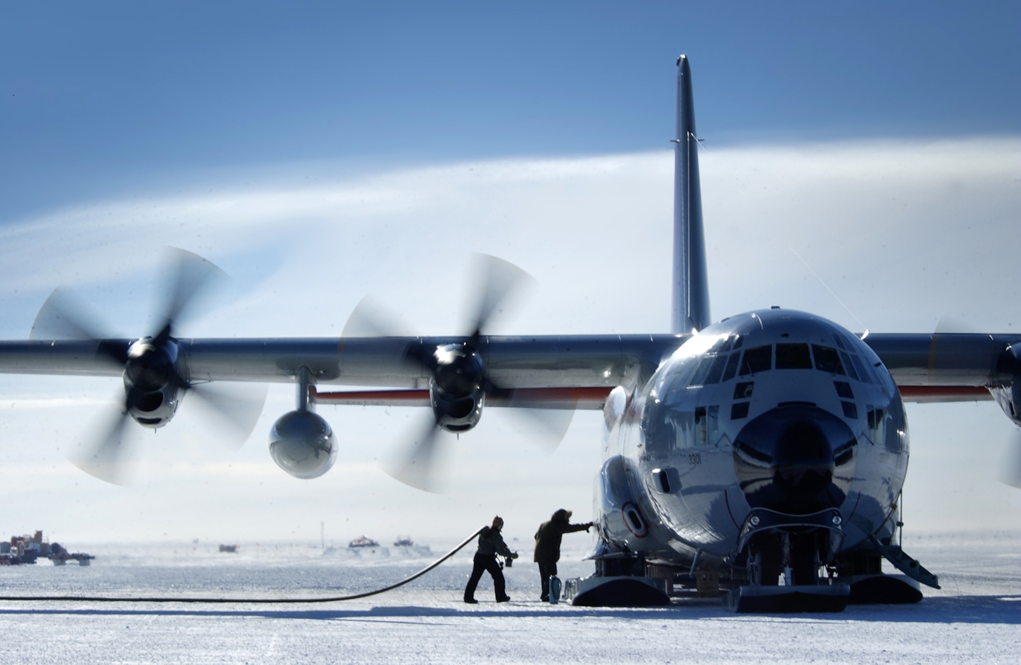 A New York Air National Guard LC-130 Hercules sits while crews unload fuel and cargo here during a mission to Antartica in 2005. A LC-130 arrived Oct. 17 at Hickam Air Force Base, Hawaii, en route to its first Operation Deep Freeze mission for the year. The LC-130 is equipped with ski-landing gear that allows the aircraft to land on ice or snow while airlifting supplies to remote locations throughout the Antarctic continent.  (U.S. Air Force photo/Master Sgt. Efrain Gonzalez)