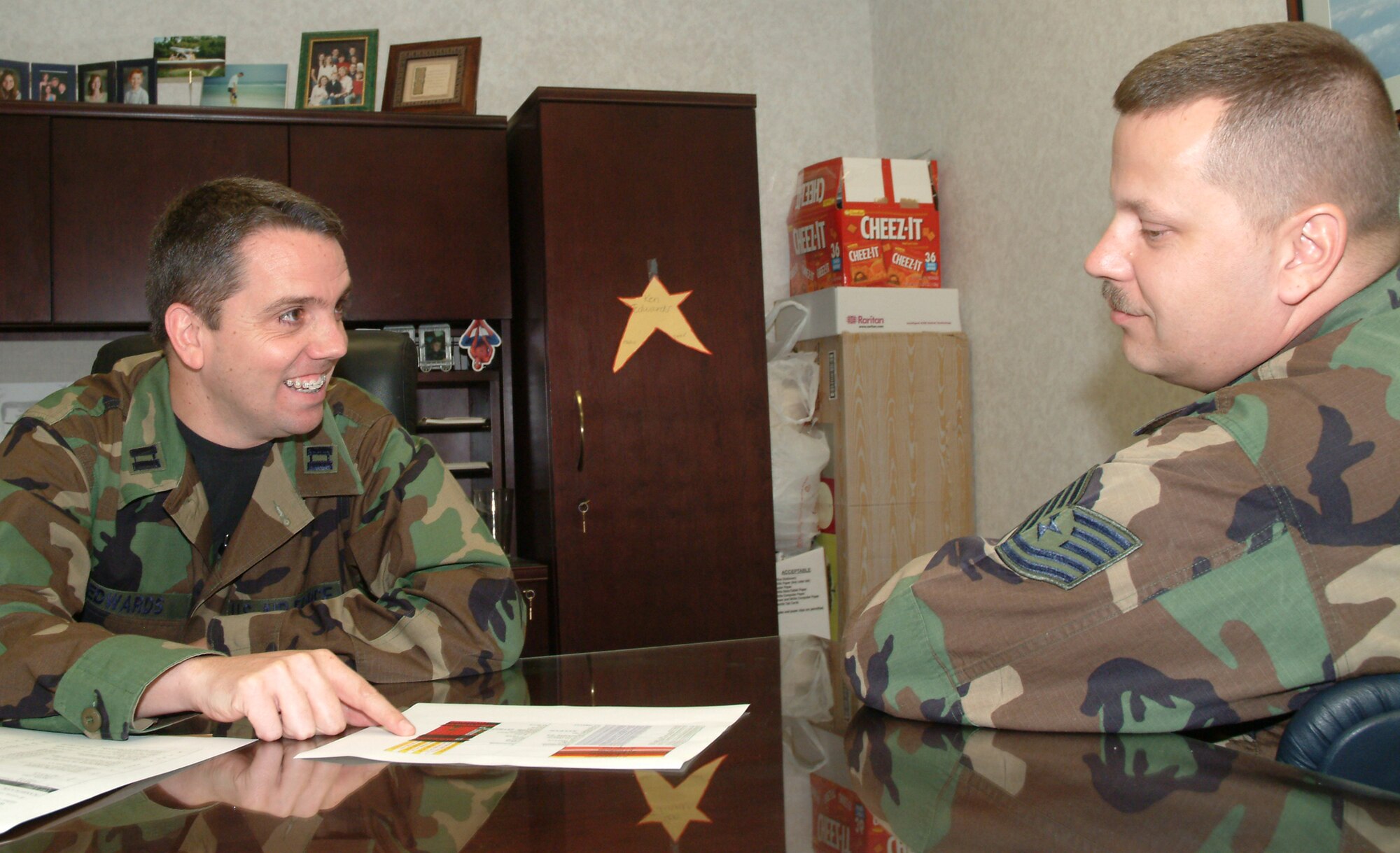 Capt. Kenny Edwards, 53d Test Management Group executive officer, discusses TMG business with Tech Sgt. Timothy Neff, 53d TMG.  Photo by Staff Sgt. Samuel King Jr.