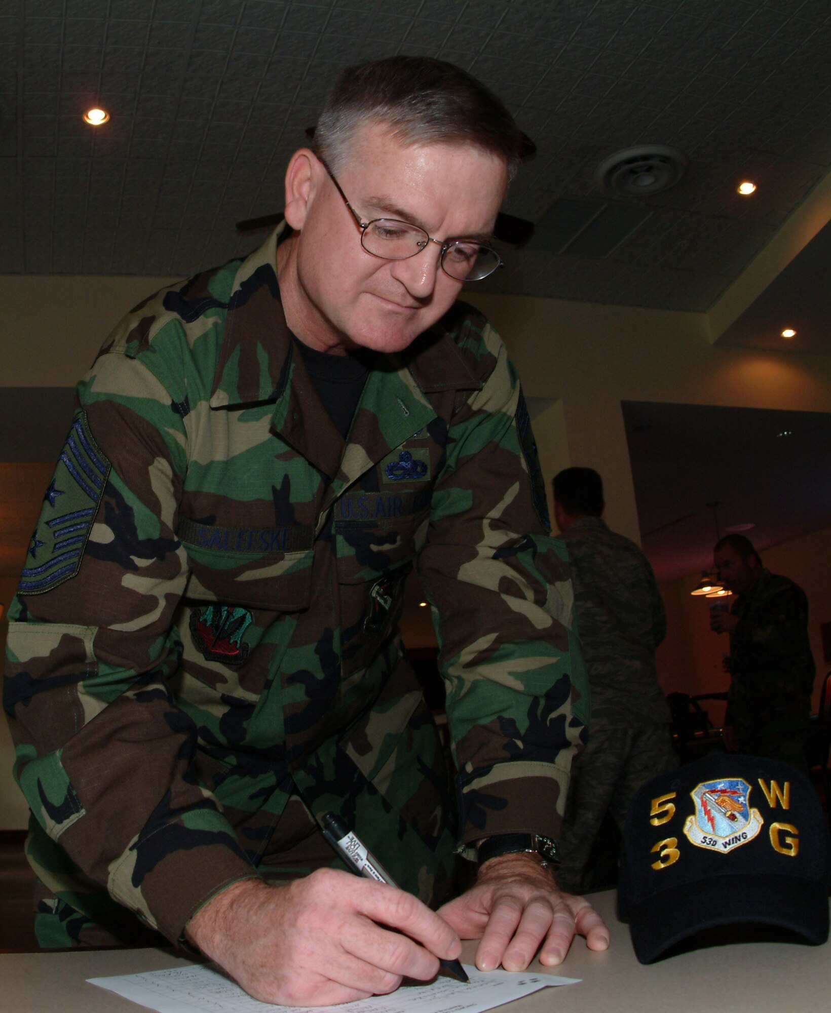 Chief Randy Salefske, 53d Wing's new command chief, signs in as the newest member of the 53d Wing Top Four.