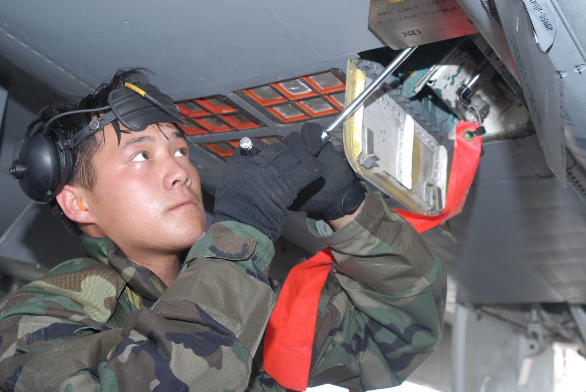 Staff Sgt. Fong Vang adjusts equipment on an F-15 Eagle during an combat capability exercise Oct. 18 at Kadena Air Base, Japan. The 18th Wing exercise from Oct. 13 to 19 tested the wing's ability to respond to a wartime situation. Sergeant Vang is assigned to the 18th Aircraft Maintenance Squadron. (U.S. Air Force photo/Tech. Sgt. Dave DeRemer)
