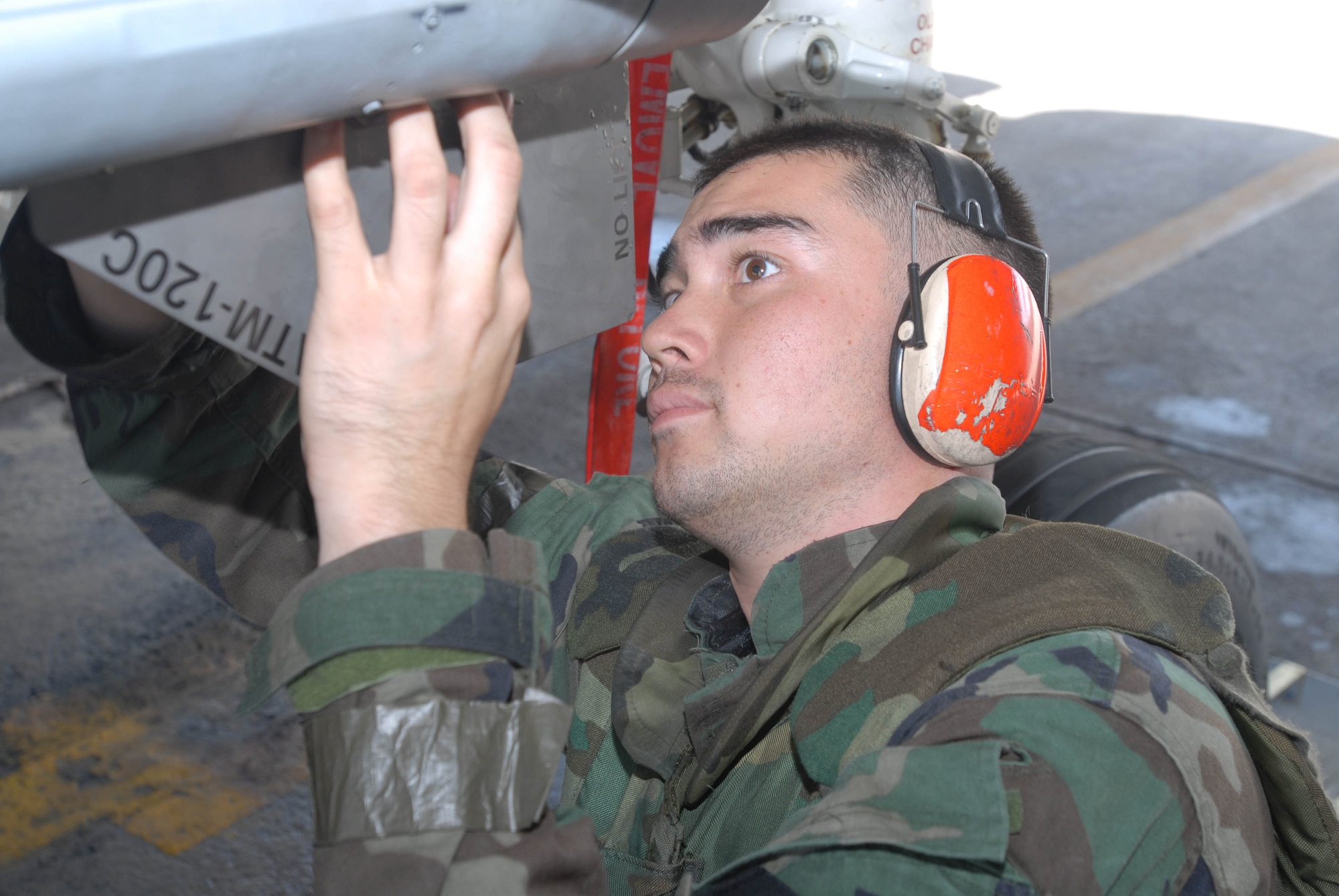 Senior Airman Christopher Kratz adjusts an AIM 120 air-to-air missile on an F-15 Eagle during an combat capability exercise Oct. 18 at Kadena Air Base, Japan. The 18th Wing exercise from Oct. 13 to 19 tested the wing's ability to respond to a wartime situation. Airman Kratz is assigned to the 18th Aircraft Maintenance Squadron. (U.S. Air Force photo/Tech. Sgt. Dave DeRemer) 
