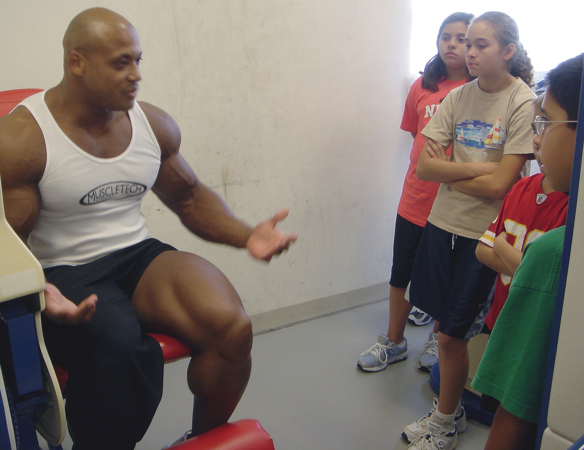 Mr. Richardson explains proper weight lifiting techniques and healthy living habits to students.  (Courtesy photo) 