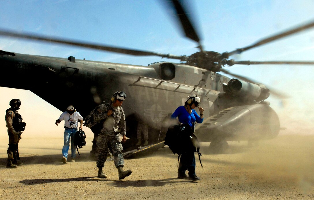 Heidi Richards, founder and CEO of Women's Ecommerce Association and participant of the Joint Civilian Orientation Conference 72, exits a MH-53 Sea Dragon at Forward Operating Base Sword, Kuwait, Oct. 19, 2006. 