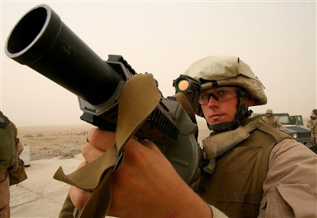 U.S. Marine Corps Lance Cpl. Evan E. Miller holds an M-32 Multiple Grenade Launcher on Camp Fallujah's Eagle Range, Oct. 16, 2006.  Miller is assigned to Weapons Company, 1st Battalion, 24th Marine Regiment.