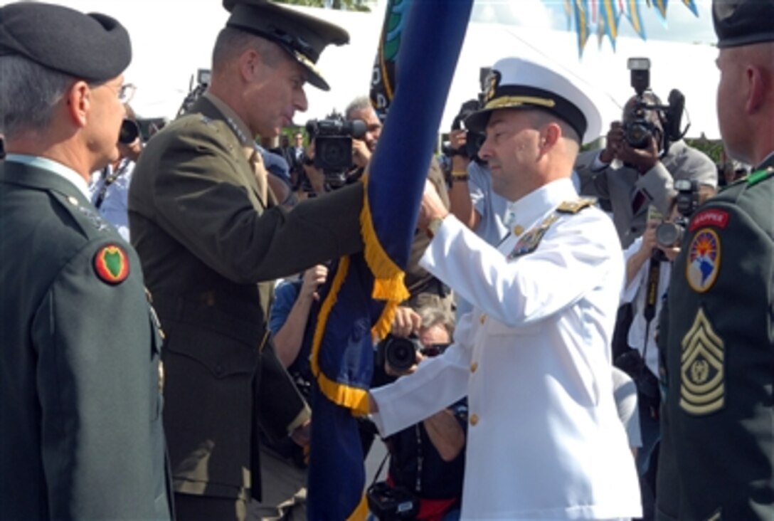 U.S. Navy Adm. James Stavridis, right, commander of U.S. Southern 
Command, receives the unit guidon from Marine Gen. Peter Pace, chairman of the Joint 
Chiefs of Staff, during a change-of-command ceremony in Miami, Fla., Oct. 19, 2006. 
