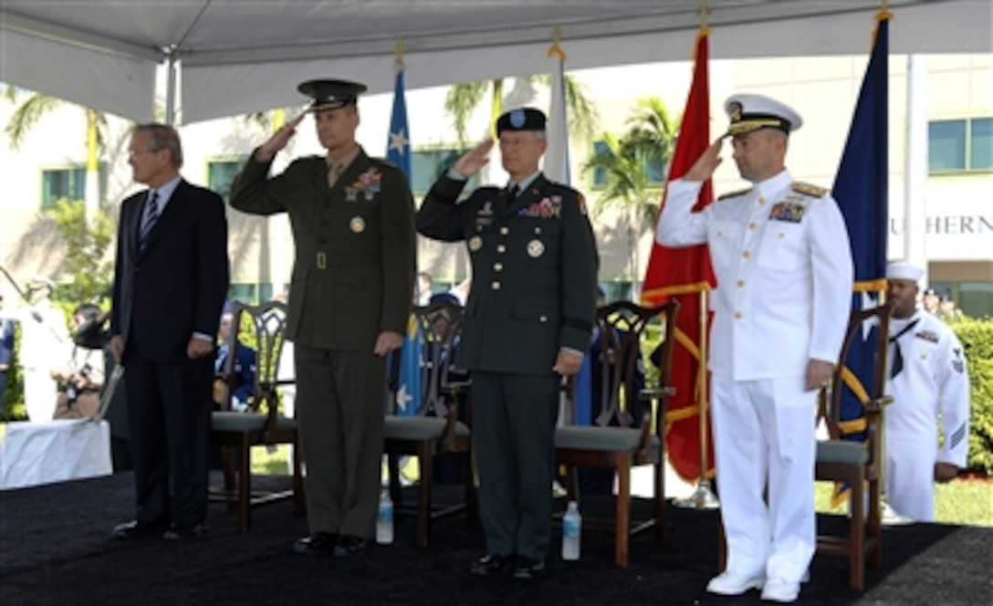 From left to right: Secretary of Defense Donald H. Rumsfeld, U.S. Marine Corps Gen. Peter Pace, chairman of the Joint Chiefs of Staff, U.S. Navy Admiral James G. Stavridis, incoming commander, and U.S. Army Gen. Bantz J. Craddock, outgoing commander, show their respect during the National Anthem at the change-of-command ceremony for the U.S. Southern Command, Miami, Fla., Oct. 19, 2006.