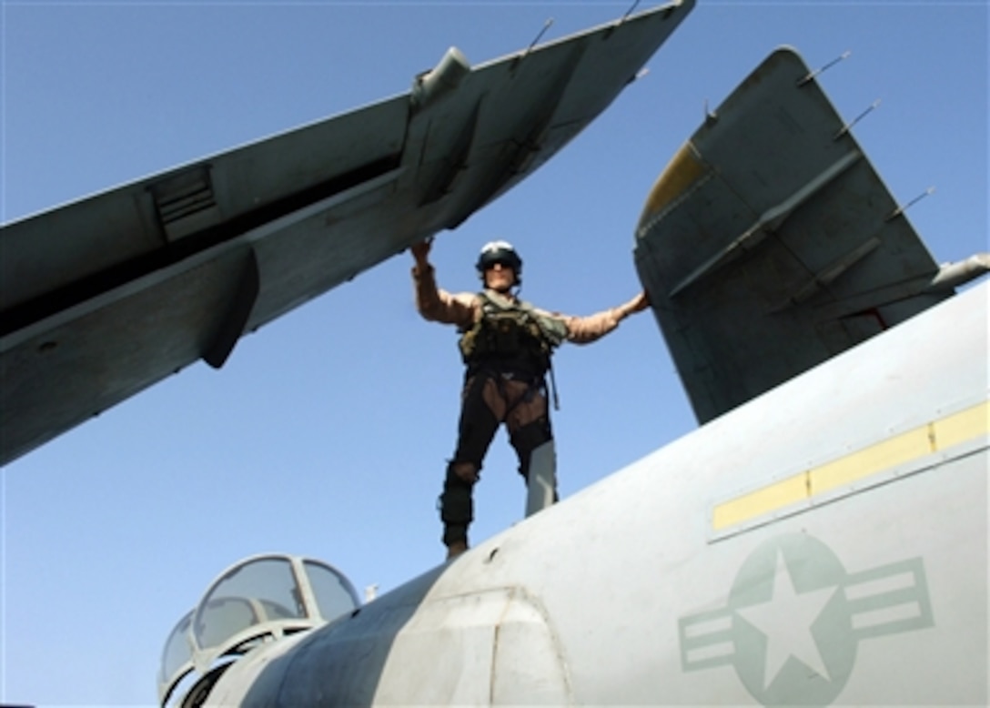 The pilot of an EA-6B Prowler aircraft performs preflight checks prior to launch on the flight deck of the nuclear-powered aircraft carrier USS Enterprise (CVN 65) on Oct. 13, 2006.  The Enterprise and embarked Carrier Air Wing 1 are on a six-month deployment in support of maritime security operations.  