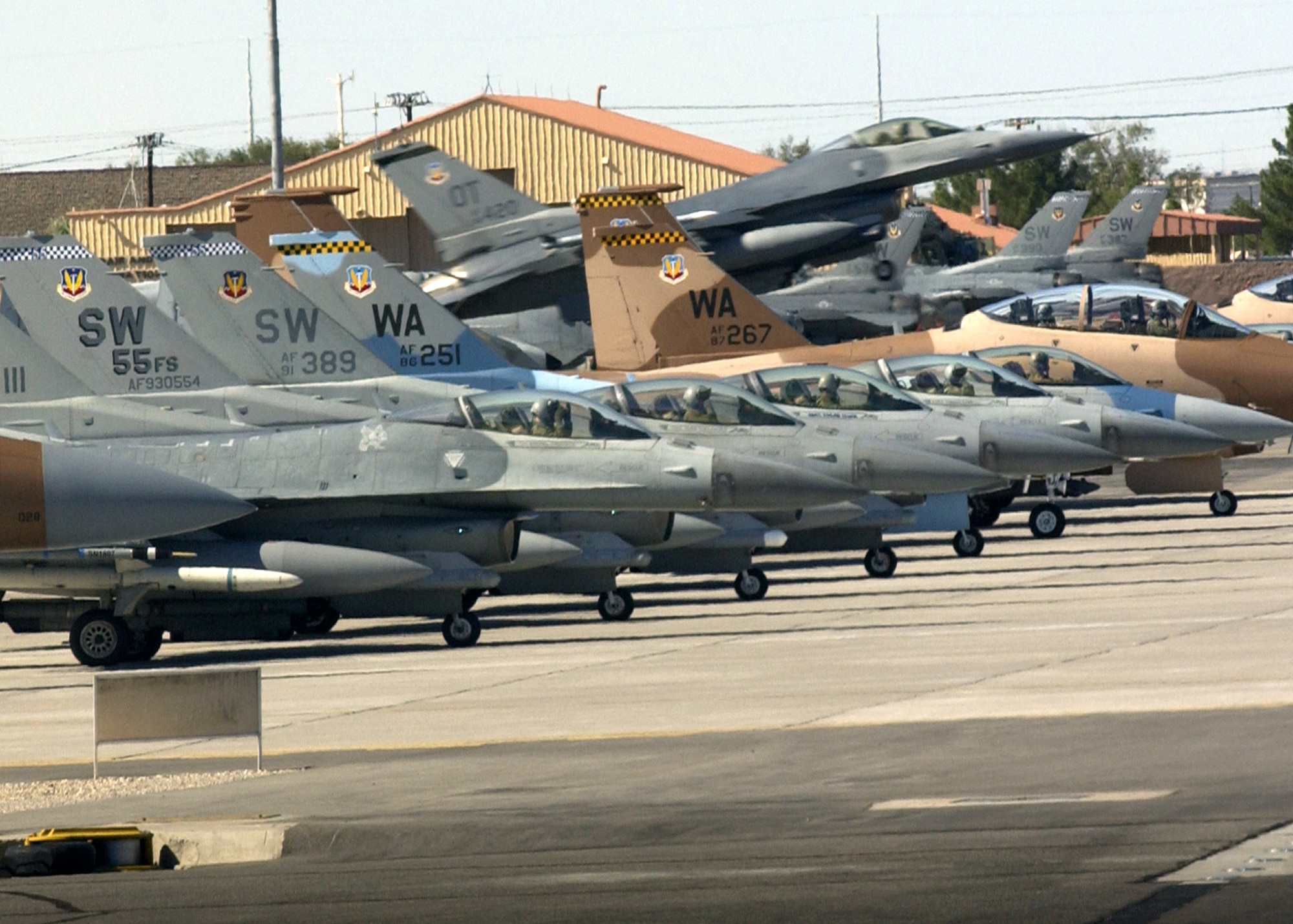 An F-16 Fighting Falcon takes off while other aircraft go through pre-flight checks Oct. 19 during Red Flag 07-1 at Nellis Air Force Base, Nev. Red Flag tests aircrew warfighting skills in realistic combat situations.  (U.S. Air Force photo/Master Sgt. Kevin J. Gruenwald)





