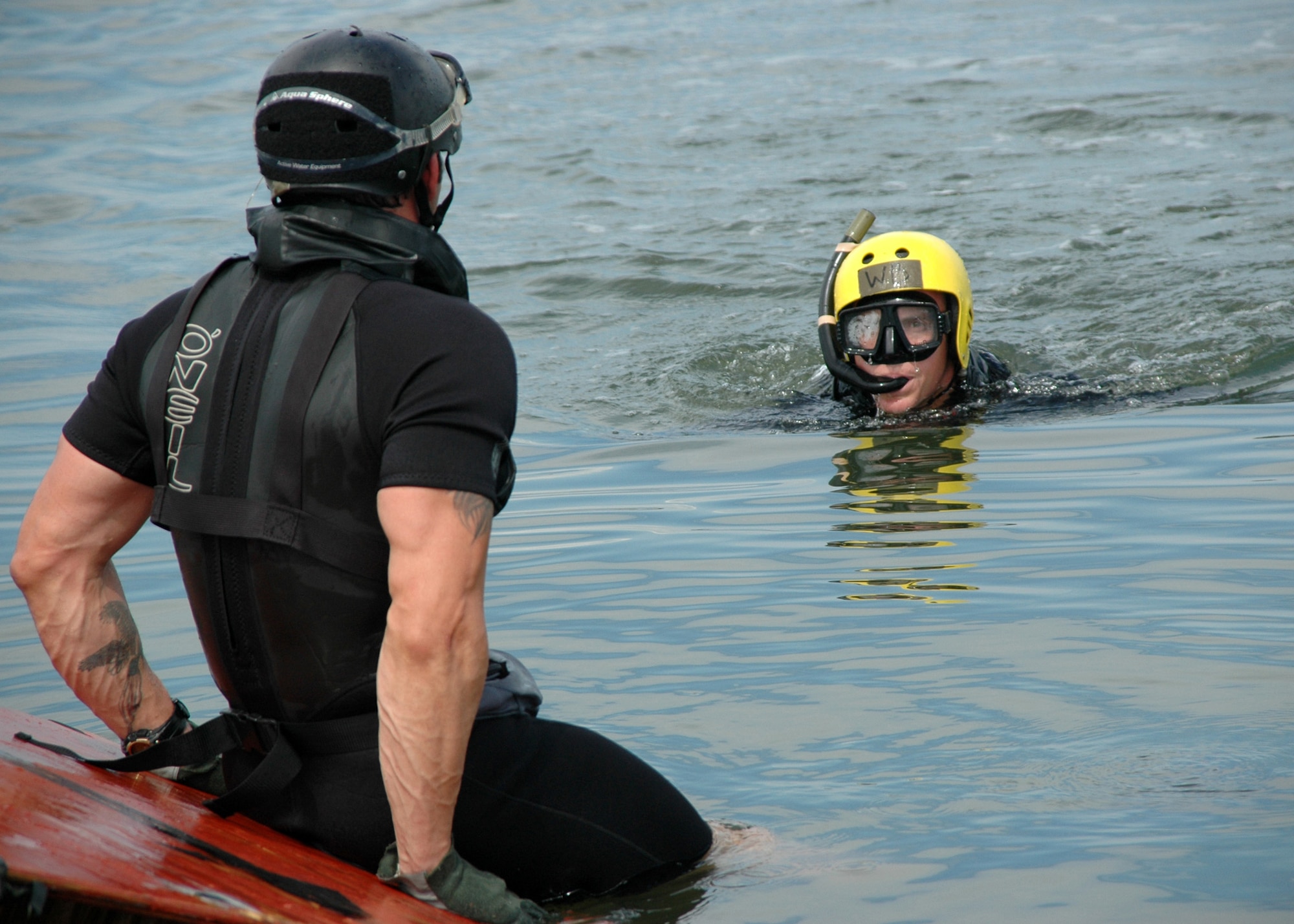 Tech. Sgt. Will Wilis, Pararescue Instructor 342nd Training Squadron (front), reaches Rigging Alternate Method Zodiac package first as Staff Sgt. Josh Webster and other air-dropped PJ trainees swim to unpack it. (U.S. Air Force photo by Senior Airman Jonathan Simmons) (Released)