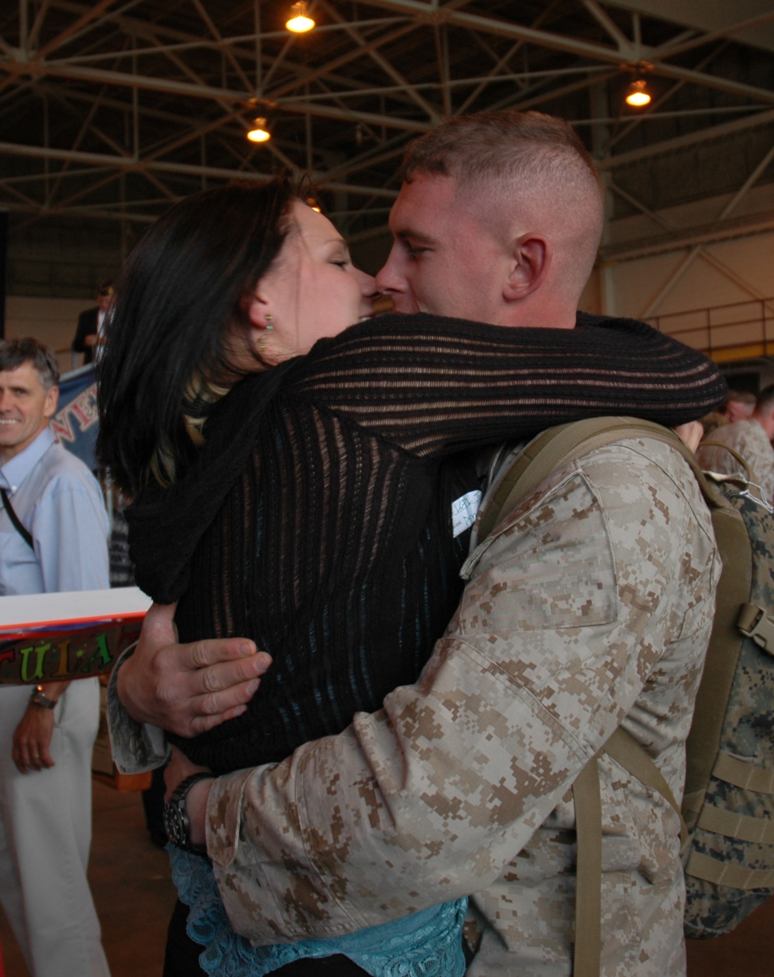 Lance Cpl. Nick Jenkins, Alpha Battery, 1st Battalion, 14th Marines, 4th Marine Division member, kisses his wife, Mrs. Amee Jenkins, after being away from her for 10 months. He and about 130 members from his unit spent about seven of those months in Iraq supporting Operation Iraqi Freedom. (U.S. Air Force photo by Senior Airman Jacque Lickteig)