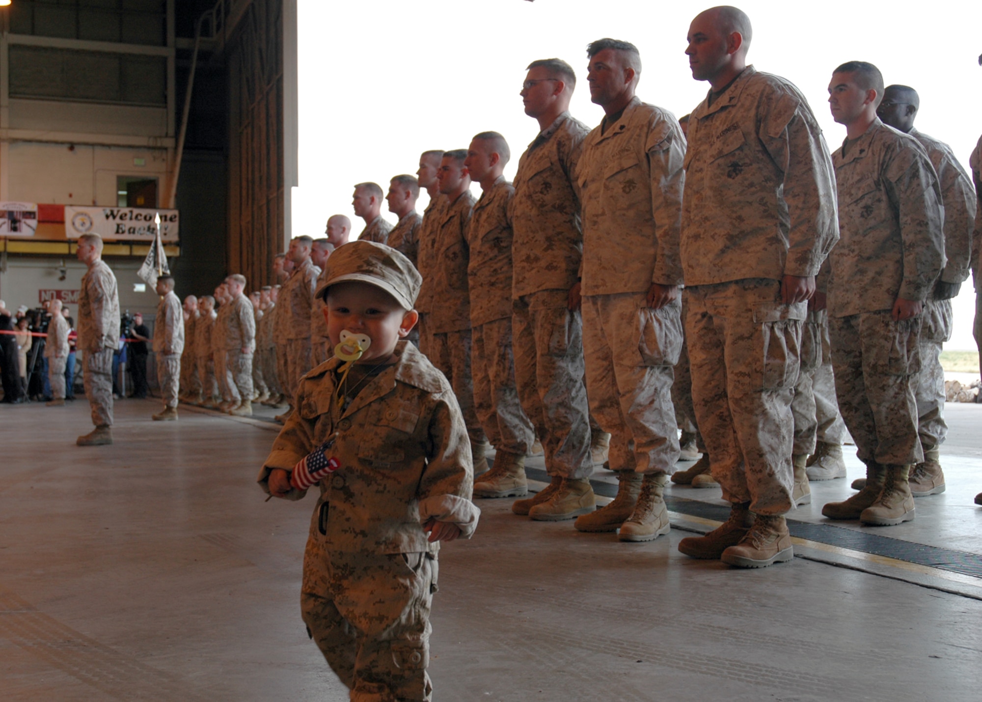 Dylan Jenkins, son of Lance Cpl. Nick Jenkins, walks in front of his father's unit, Battery A, 1st Battalion, 14th Marine Regiment, 4th Marine Division, as the members stand in formation awaiting to be released after returning home from Iraq Oct. 20. (U.S. Air Force photo by Senior Airman Jacque Lickteig)