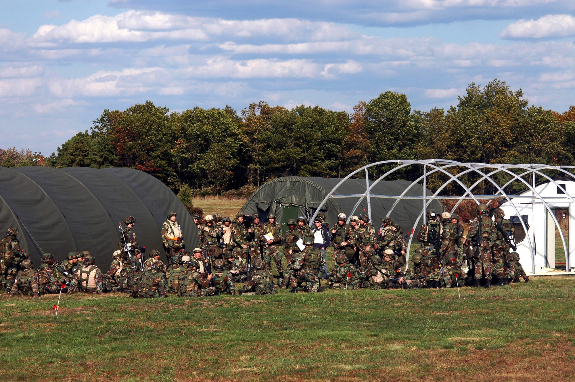 Airmen participating in Air Force Exercise Eagle Flag 07-1 as part of the "421st Air Expeditionary Group" hold a meeting to determine flow of building their main camp for the exercise Oct. 14 at Naval Air Engineering Station Lakehurst, N.J. The exercise saw more than 400 Airmen participate as they prepare for upcoming deployments. The exercise is operated by the Air Mobility Warfare Center's 421st Combat Training Squadron. (U.S. Air Force photo/Tech. Sgt. Scott T. Sturkol)

