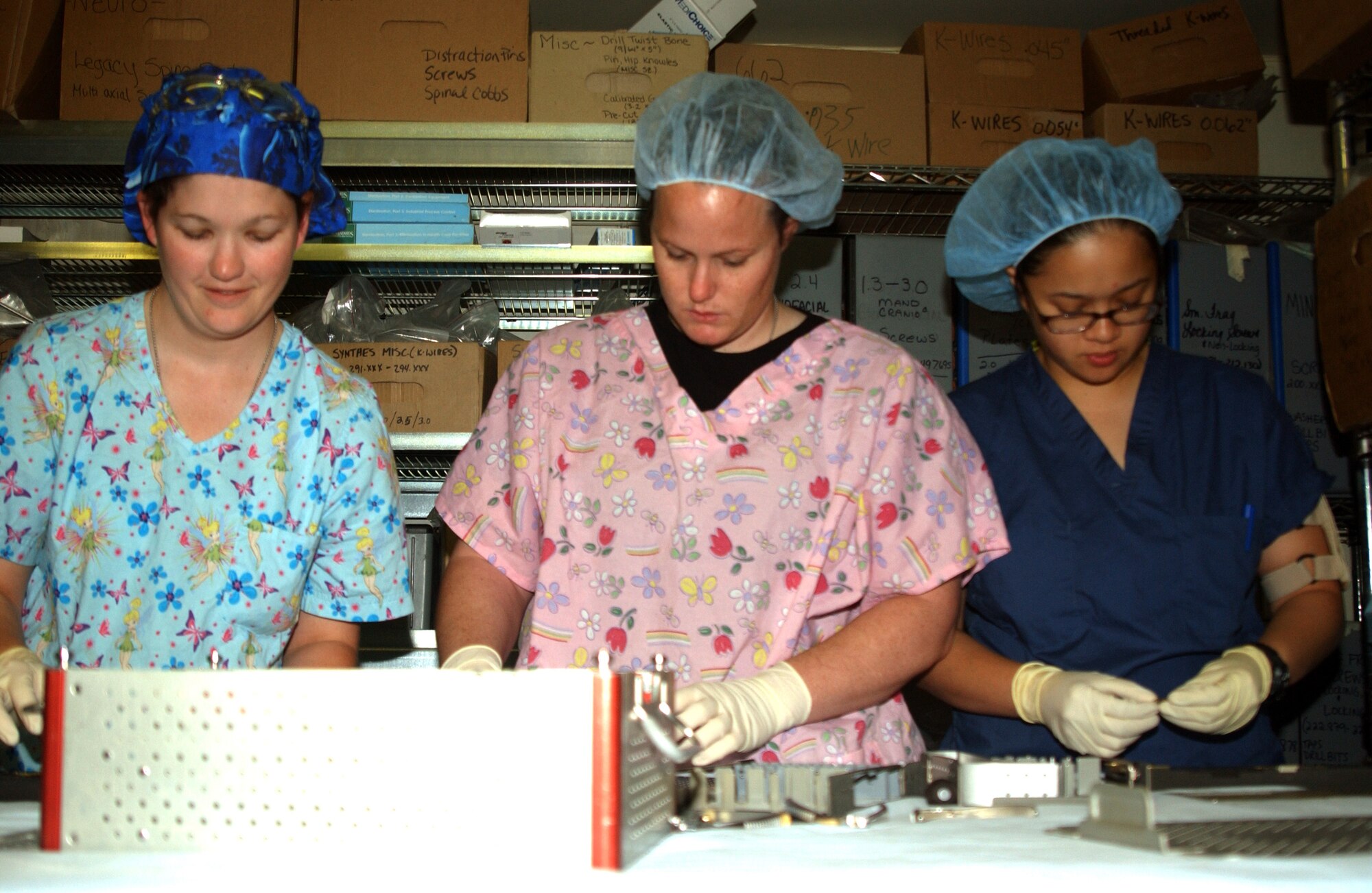 (From left) Senior Airman Shannon Brito, Airman 1st Class Sara Moore and Staff Sgt. Myla Vizcarra prepare instruments that will be used in the operating room Oct. 14 at Balad Air Base, Iraq. The Airmen are operating room technicians assigned to the 332nd Expeditionary Medical Group. (U.S. Air Force photo/Staff Sgt. Alice Moore) 