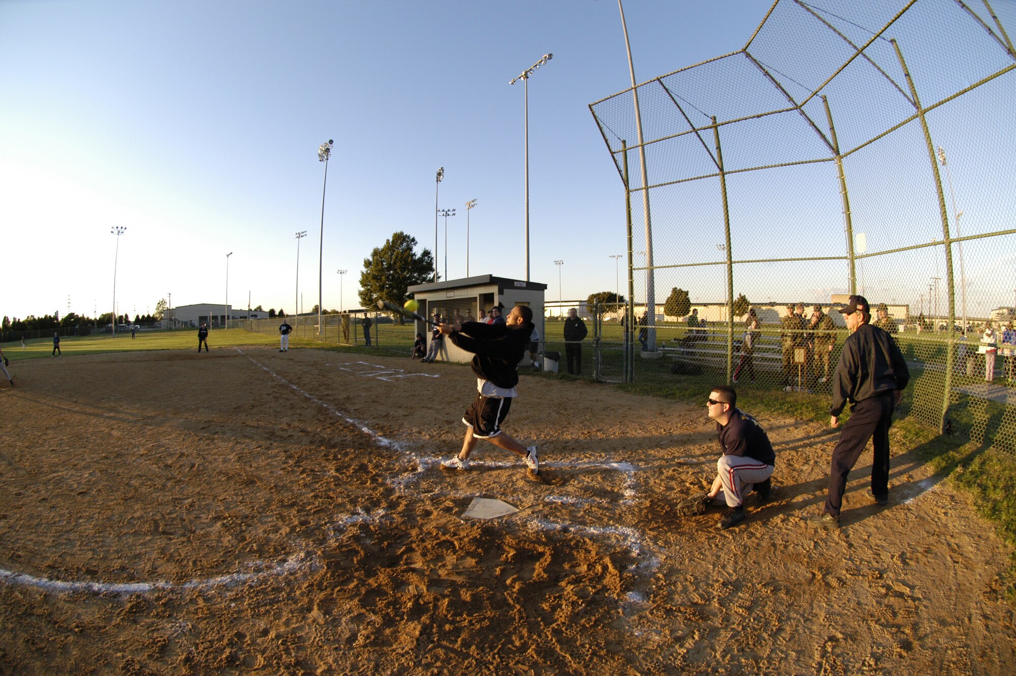 Damien Jones, 436th Civil Engineer Squadron Fire Department, cranks a ball toward right field in the last inning. The Fire Dogs defeated the Cops 15 - 9. (U.S. Air Force photo by Senior Airman James Bolinger)