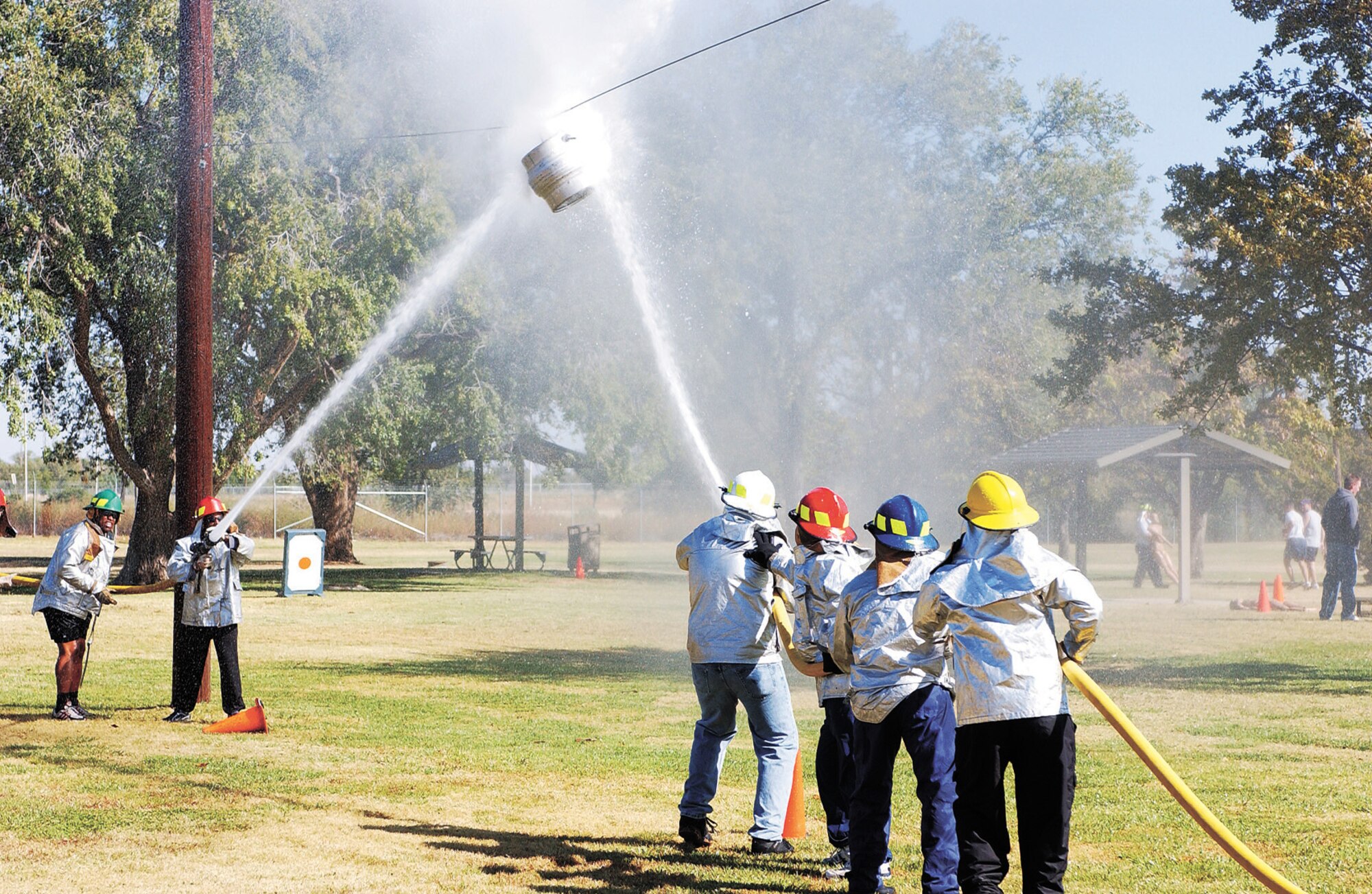 CANNON AIR FORCE BASE, N.M. -- The 27th Ccommunications Squadron and the 27th Civil Engineer Squadron test their spraying accuracy by pushing a keg across a wire in the Waterball competition at the annual Fire Muster Oct. 13. (U.S. Air Force photo/ Airman 1st Class Randi Rickards)