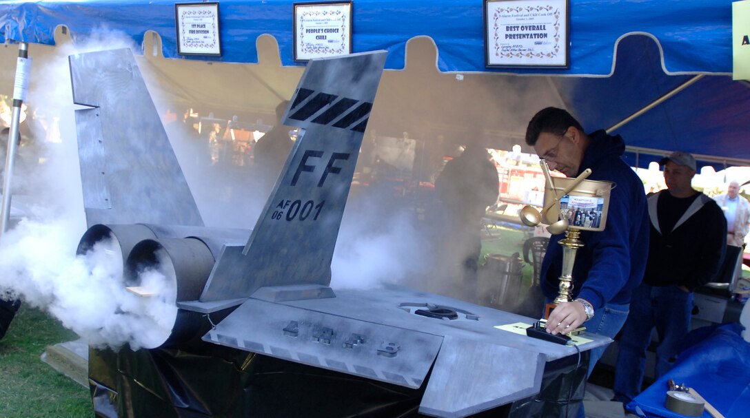 Robert Kerby, Langley Fire Department station chief, adjusts the “thrust” on their chili server for the annual Firefighter Chili Cook Off in Hampton. Langley firefighters defended their title and received the People’s Choice Award, the Most Likely to Produce Methane award and the award for Best Presentation. (Photo by Airman 1st Class Christopher Ingersoll)