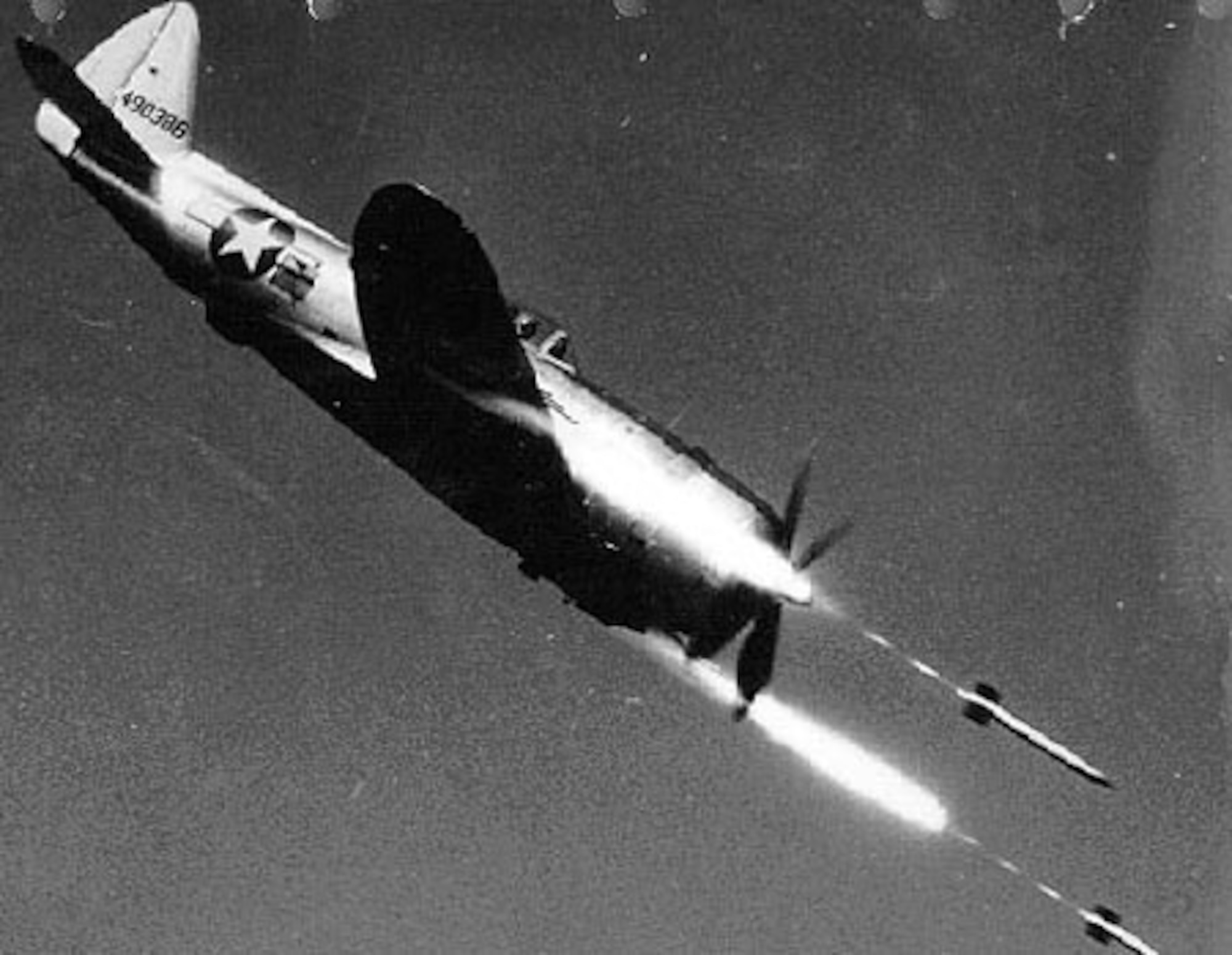 Republic P-47D-40-RE (S/N 44-90386) in flight firing rockets. (U.S. Air Force photo)