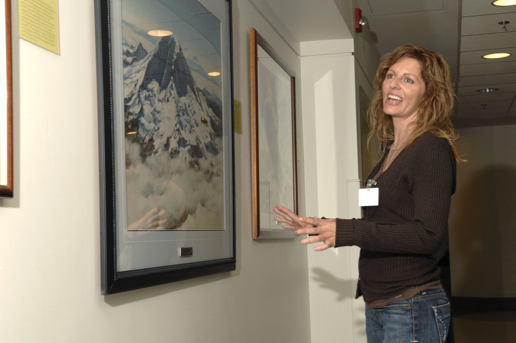 Artist Mia Tavonatti, one of many artists who contribute to the Air Force art program, looks at some of the paintings that line the walls of the Air Force-maintained areas of the Pentagon.  She was one of the many artists who were invited to a special ceremony Oct. 19 at the Pentagon to commemorate the 60th Anniversary Art Exhibit.  (U.S. Air Force photo/Tech. Sgt. Cohen Young)
