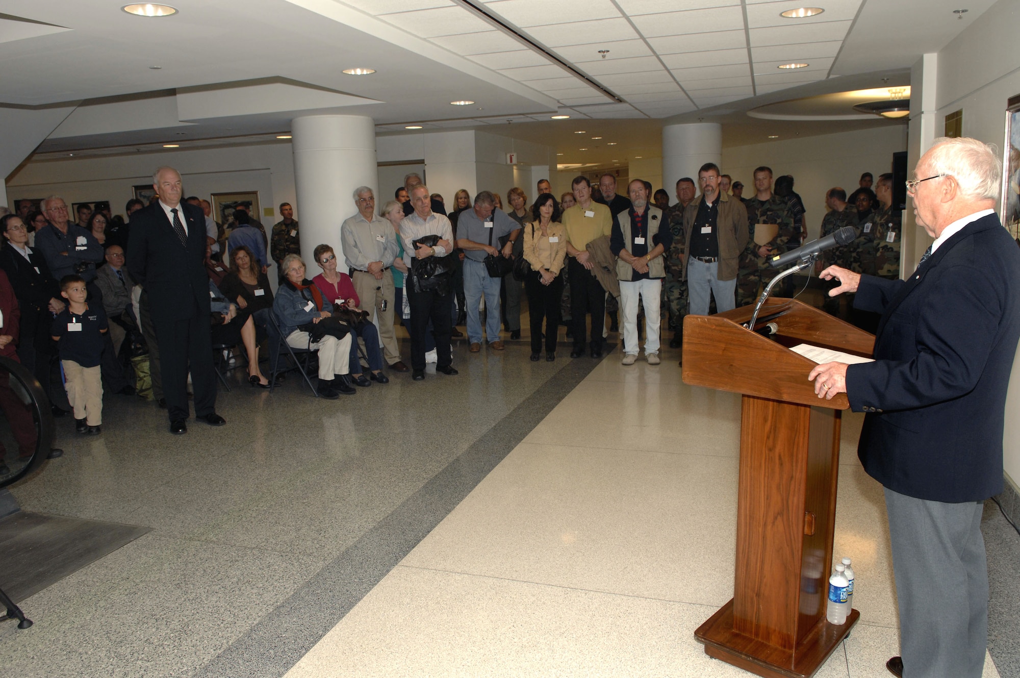 Secretary of the Air Force Michael W. Wynne and guests and artists listen as artist Keith Ferris recounts the expansion of the Air Force art program during a ceremony Oct. 19 at the Pentagon commemorating the 60th Anniversary Art Exhibit.  The paintings line the walls of the Air Force-maintained areas of the Pentagon.  (U.S. Air Force photo/Tech. Sgt. Cohen Young)