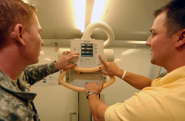 Joseph Wargo (right), U.S. Army Medical Materiel Agency electronic technician, shows Spc. Russell Hamblin, 226th Medical Logistics Battalion, how to perform an operational check on the X-ray machine at one of the 212th Mobile Army Surgical Hospital’s warehouses on Miesau Army Depot in Kaiserslautern. Photo by Christine June