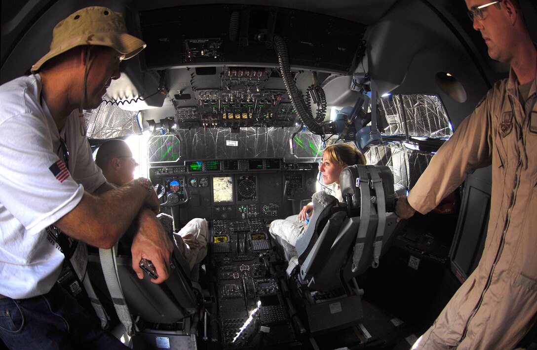 David Pillsbury speaks with U.S. Air Force Capt. Russ Paramone, right, Senior Amn.  Christine Gail, center, and Senior Amn. Bufkin Fairchild on the flight deck of a C-130J Super Hercules in Southwest Asia, Oct. 20, 2006.  Pillsbury is the president and Chief Operating Officer of PGA TOUR Golf Course Properties and a participant in the Joint Civilian Orientation Conference 72.
