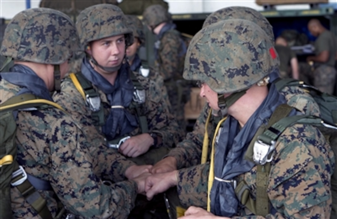 U.S. Marines, from 3rd Air Delivery Platoon, Combat Logistics Company 38, Combat Logistics Regiment 3, gather in a hangar at Clark Air Base, Philippines, Oct. 18, 2006, before participating in an air delivery exercise.  The Marines are participating in training exercises Talon Vision and Amphibious Landing Exercise '07.