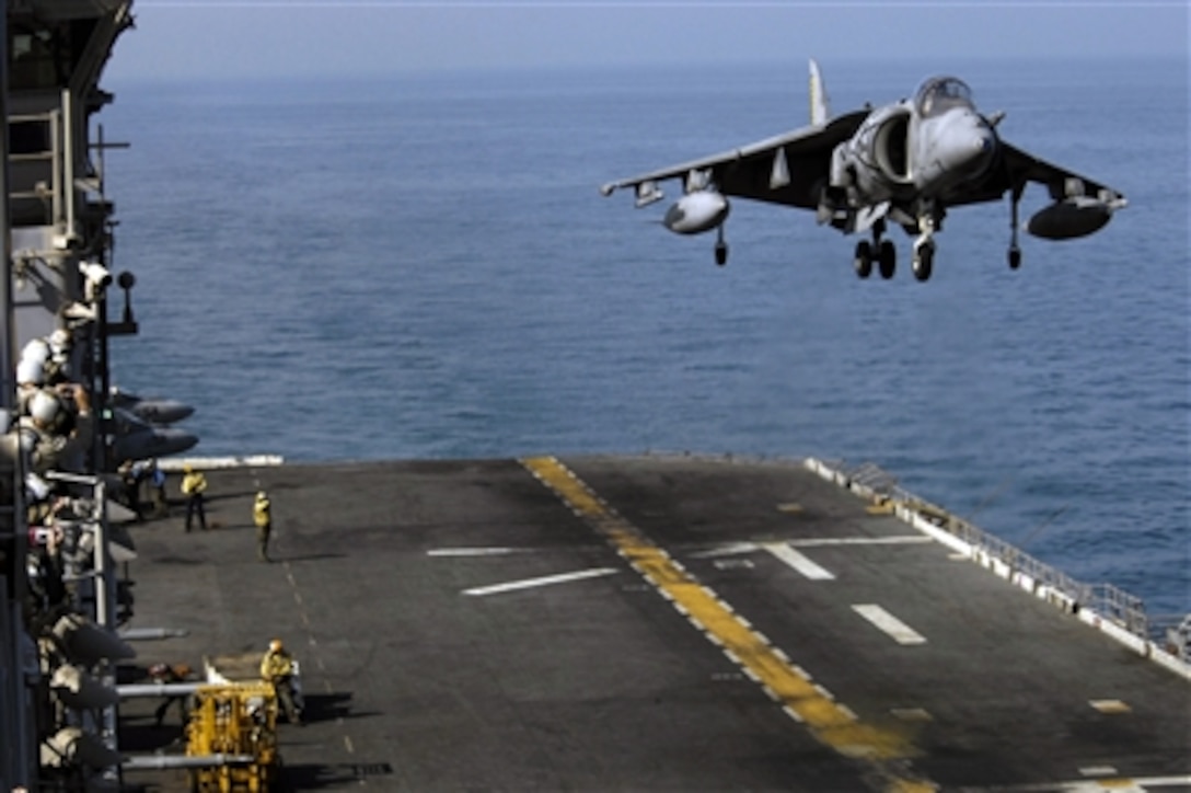 An AV-8B Harrier II aircraft lands on the flight deck of the USS Iwo Jima after performing an aerial demonstration for participants of the Joint Civilian Orientation Conference 72, Oct. 18, 2006.