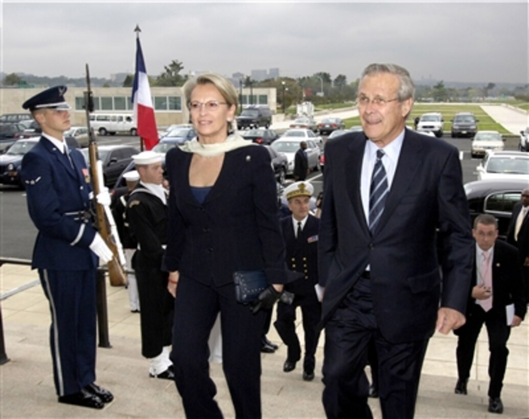 Secretary of Defense Donald H. Rumsfeld (right) escorts French Minister of Defense Michelle Alliot-Marie through an honor cordon and into the Pentagon on Oct. 19, 2006.  Rumsfeld and Alliot-Marie will meet to discuss a range of international issues of interest to both nations.  
