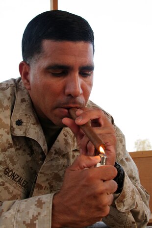 Lt. Col. Gilbert C. Gonzalez lights a cigar during a get together of the Lamplighter's Club in the "Don's Cabana" at Al Asad, Iraq, Oct. 20. Gonzalez is the commanding officer for Marine Air Control Group 38 (Reinforced), 3rd Marine Aircraft Wing (Forward). He is a native of San Diego.