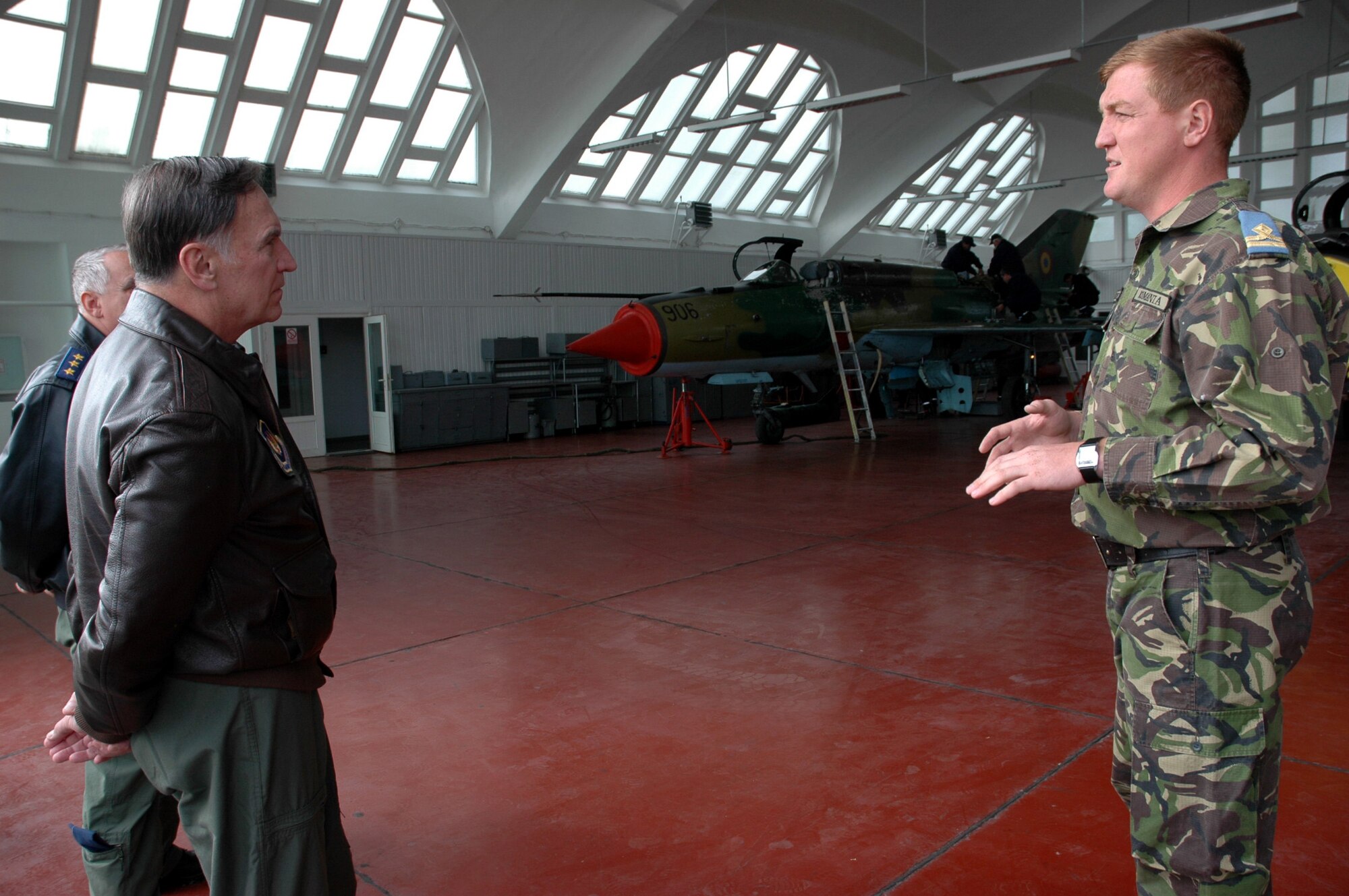 Gen. Tom Hobbins (left) receives an orientation briefing at a maintenance hangar from Romanian First Lieutenant Peceta during a visit to Fetesti Air Base, Romania, Oct. 20. General Hobbins is the U.S. Air Forces in Europe commander. (U.S. Air Force Photo/Capt. Elizabeth Culbertson)