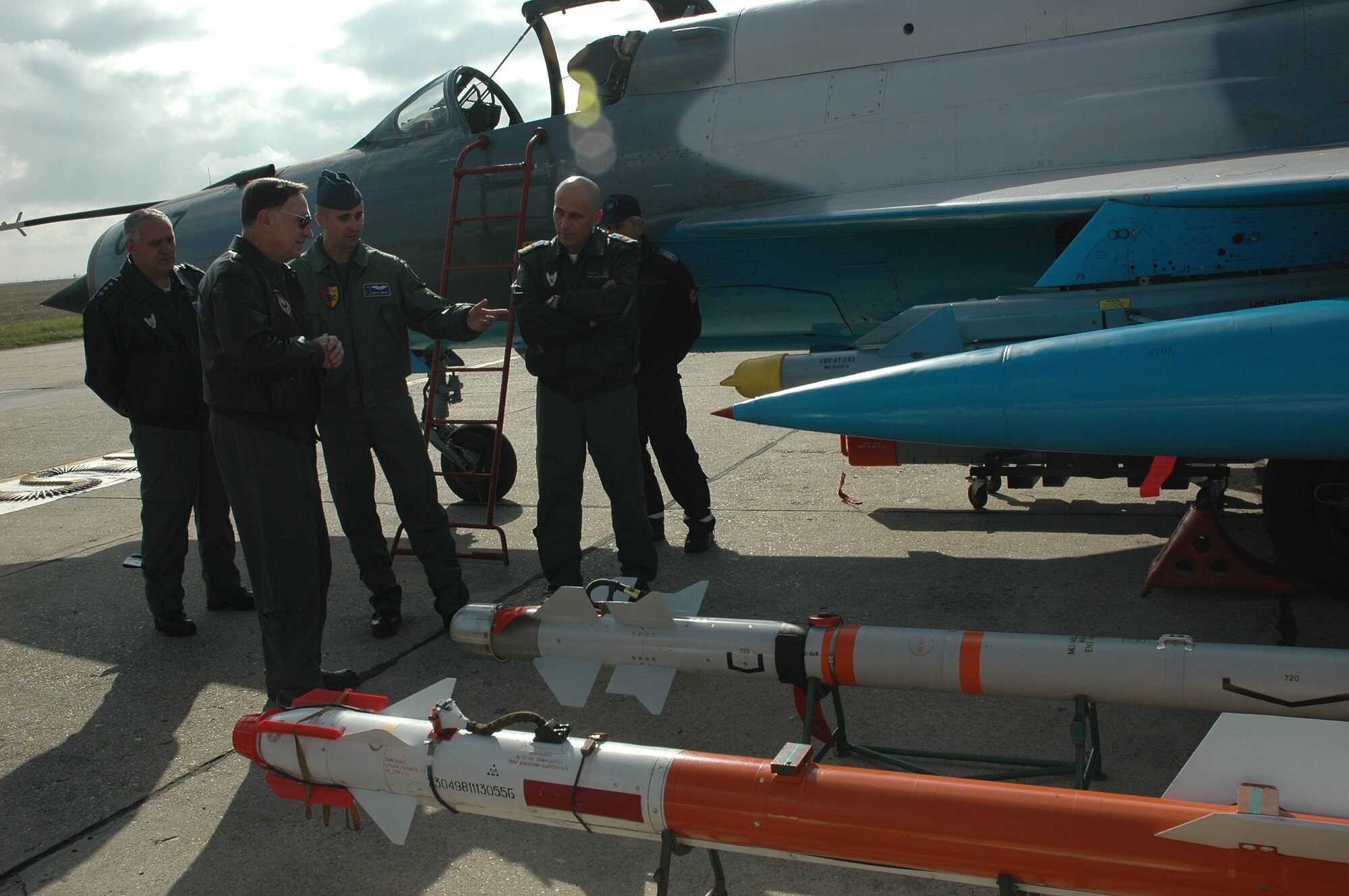 FETESTI AIR BASE, Romania--Gen. Tom Hobbins (second from left), U.S. Air Forces in Europe commander, Romanian Lt. Gen. Gheorghe Catrina (left), Romanian Air Force Chief of Staff, and Romanian CDR Dan Buciuman, Festesti Air Base commander,  receive a briefing on MiG-21 munitions by Romanian First Lieutenant Mihaita Marin during the general's base visit Oct. 20. (U.S. Air Force Photo/Capt. Elizabeth Culbertson)