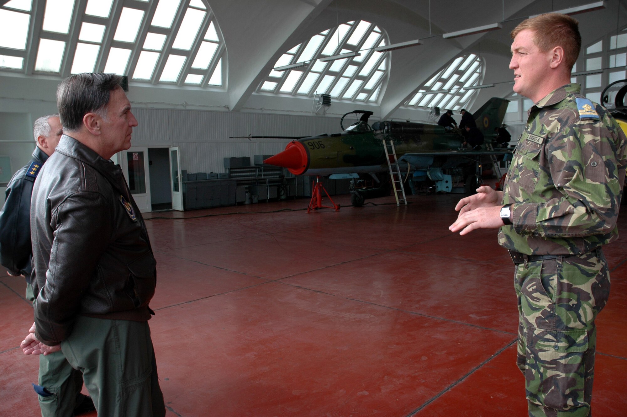 FETESTI AIR BASE, Romania--Gen. Tom Hobbins (left), U.S. Air Forces in Europe commander, receives an orientation briefing to a maintenance hangar by Romanian First Lieutenant Peceta during the general's base visit Oct. 20. (U.S. Air Force Photo/Capt. Elizabeth Culbertson)