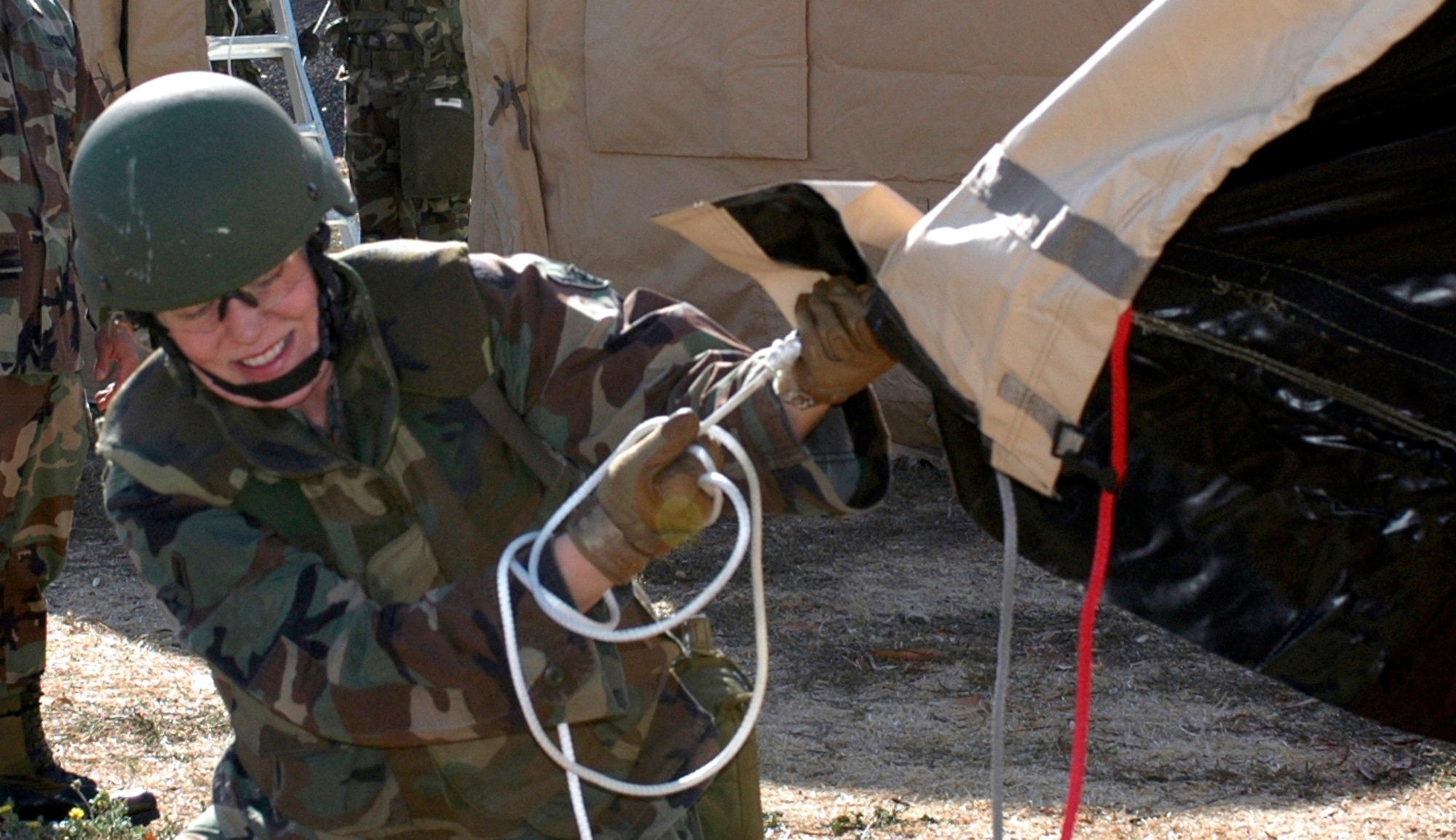 Airman Lauren Frost, 571st Global Mobility Readiness Squadron, finishes pulling the tent shell, which weighs approximately 80 pounds, over the aluminum frame of an Alaska Shelter. The shell is then tied down to the bottom rails of the frame. The winning team received trophies for their quick work and innovative planning. (U.S. Air Force photo by Jennifer Brugman/60th AMW Public Affairs)