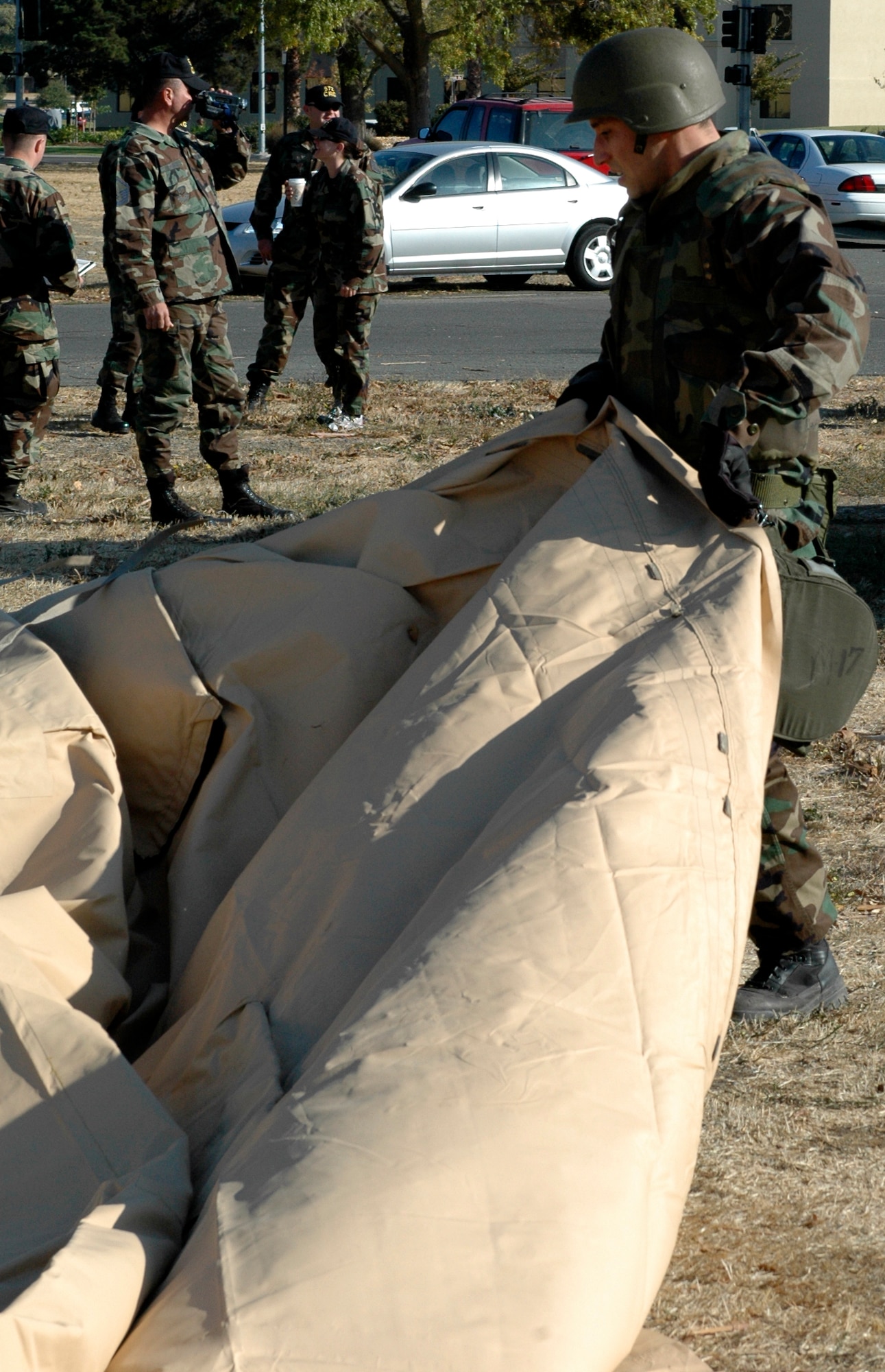 Senior Airman Christopher Frederick, 572nd Global Mobility Squadron, arranges the tent shell on the ground. The second place team, 570th Global Mobility Squadron, at the Alaska challenge came in 39 seconds behind the first place team, 572nd GMS. (U.S. Air Force photo by Jennifer Brugman/60th AMW Public Affairs)