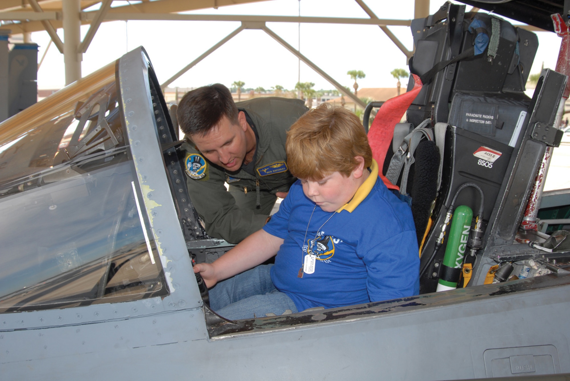 TYNDALL AFB, Fla. --  Ryan McGraw checks out the inside of an F-15 Eagle cockpit with Maj. Nick Kavouras, 95th Fighter Squadron instructor pilot. Ryan participated in the second Pilot for a Day held by the 95th FS here. (U.S. Air Force photo by Lisa Norman)