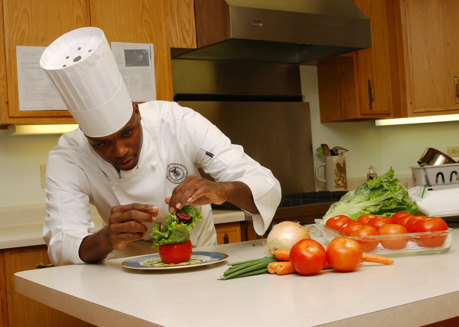 Master Sgt. Roy Bowser, enlisted aide for Gen. William R. Looney III, commander of Air Education and Training Command, prepares a salad for an official function. Sergeant Bowser was selected as the 2006 Enlisted Aide of the Year Award for the Senior-Aide Category Oct. 12. (U.S. Air Force photo by Melissa Peterson)