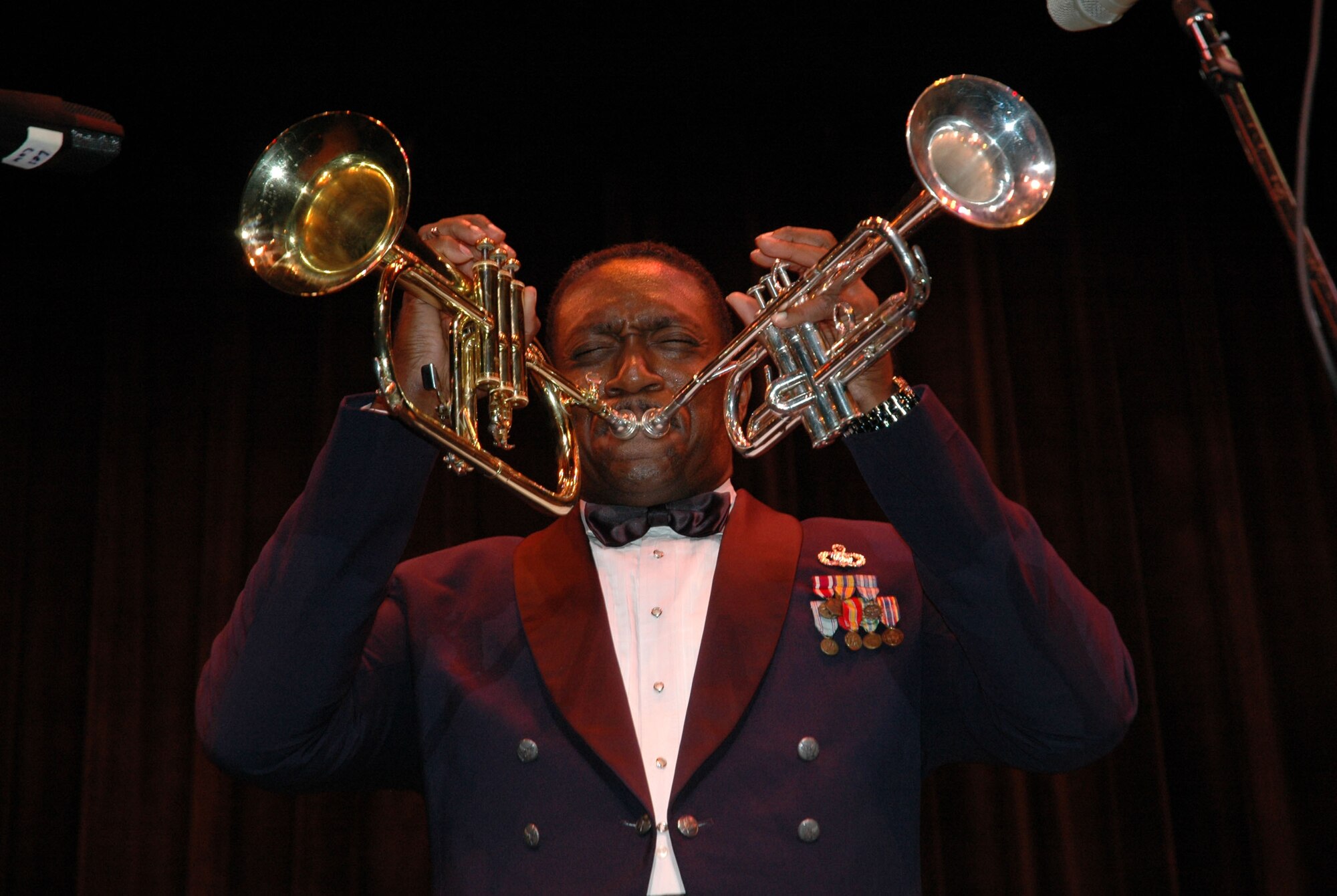 Master Sgt. Ken Trimmins, noncommissioned officer of the Air Force Reserve Band's Full Spectrum, performs at Delaware State University at the Schwartz Center in Dover, Del., Oct. 20 as part of the 512th Airlift Wing Band Strike Package. Sergeant Trimmons was featured on the Jay Leno Show in 2002 for his unique ability to play two trumpets simultaneously. 