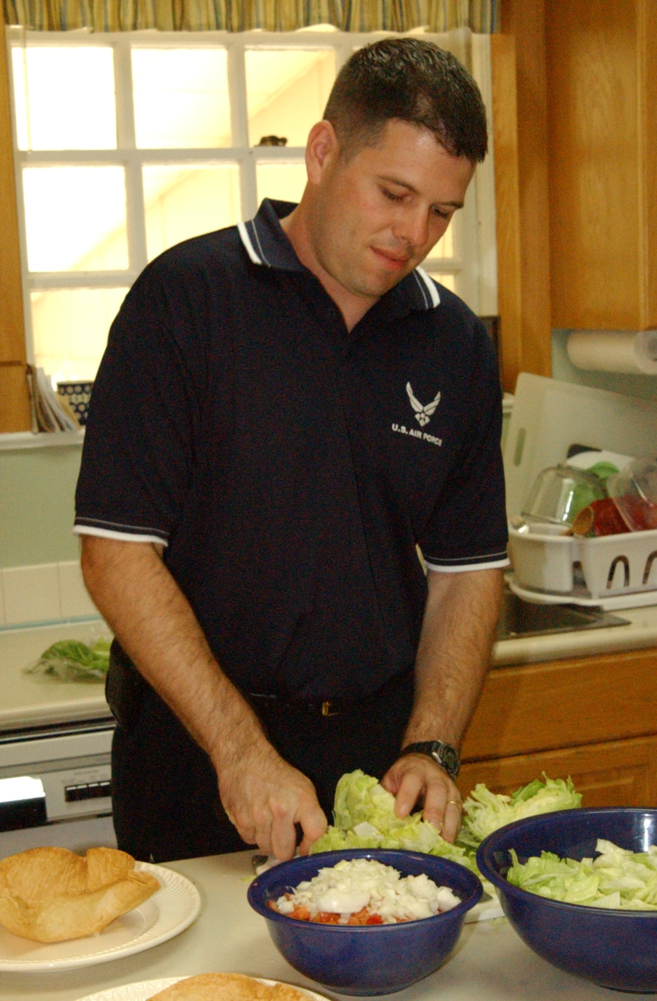 Tech. Sgt. Gregory Krems, enlisted aide to the Air University commander, prepares salad at the Curry House, Maxwell Air Force Base, Ala. Sergeant Krems earned distinction as the 2006 Air Force Junior Enlisted Aide of the Year. (U.S. Air Force photo by Jon Sladek)