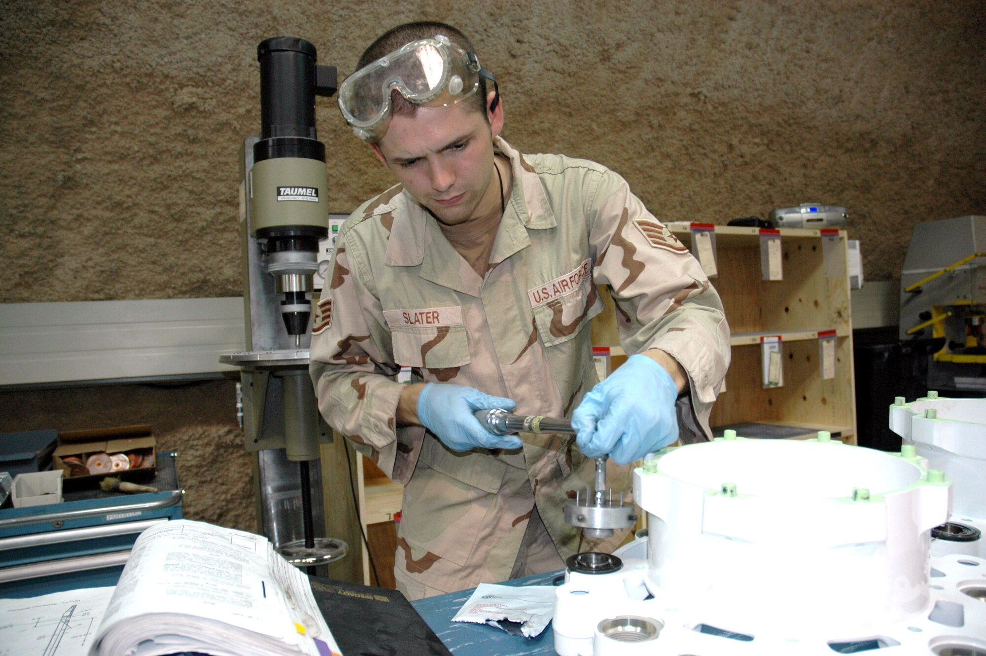 Staff Sgt. Joshua Slater, 379th Expeditionary Maintenance Squadron, installs a brake piston bushing on a KC-135 Stratotanker brake assembly.  Sergeant Slater is a maintainer in the squadron's new centralized intermediate repair facility.. (U.S. Air Force photo/Maj. Ann P. Knabe)
