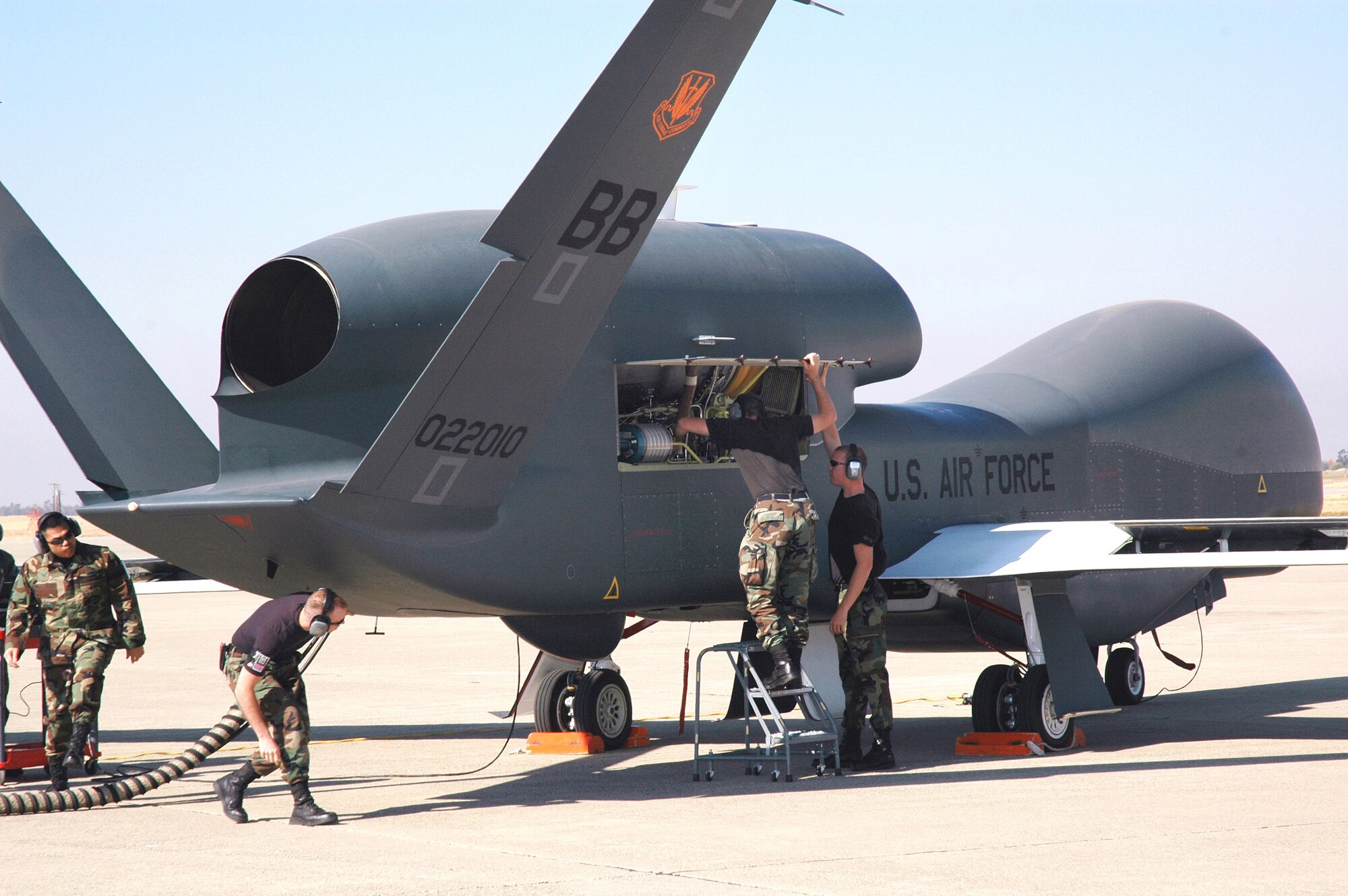 Avionics specialists with the 12th Aircraft Maintenance Unit prepare a Global Hawk for a runway taxi test at Beale Air Force Base, Calif. The Global Hawk is scheduled to begin flying at Beale in early November. The program is a total force effort with the Air Force Reserve's 13th Reconnaissance Squadron assisting active duty personnel. (U.S. Air Force photo/Stacey Knott)