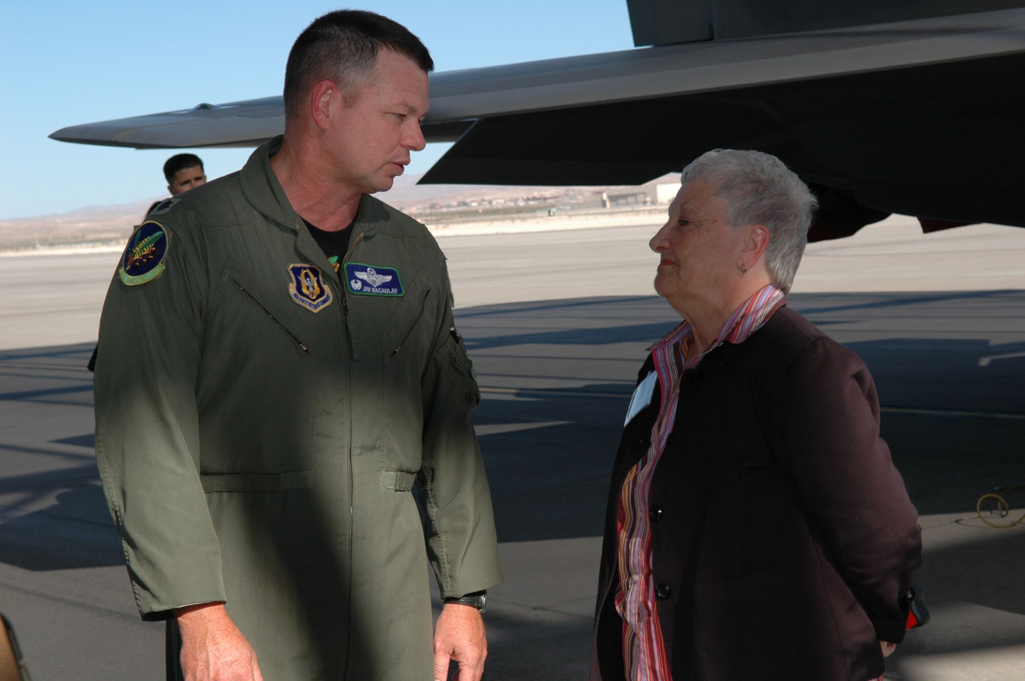Lt. Col. Jimbo Macaulay, 47th Fighter Squadron commander, talks with Helen Black, community relations director for Horseshoe/Harrahs Louisiana Downs, at the F-22A Raptor static display during this year's Wing Civic Leader Tour Oct. 11-12 at Nellis AFB, Nev. (U.S. Air Force photo/Tech. Sgt. Sherri Savant)