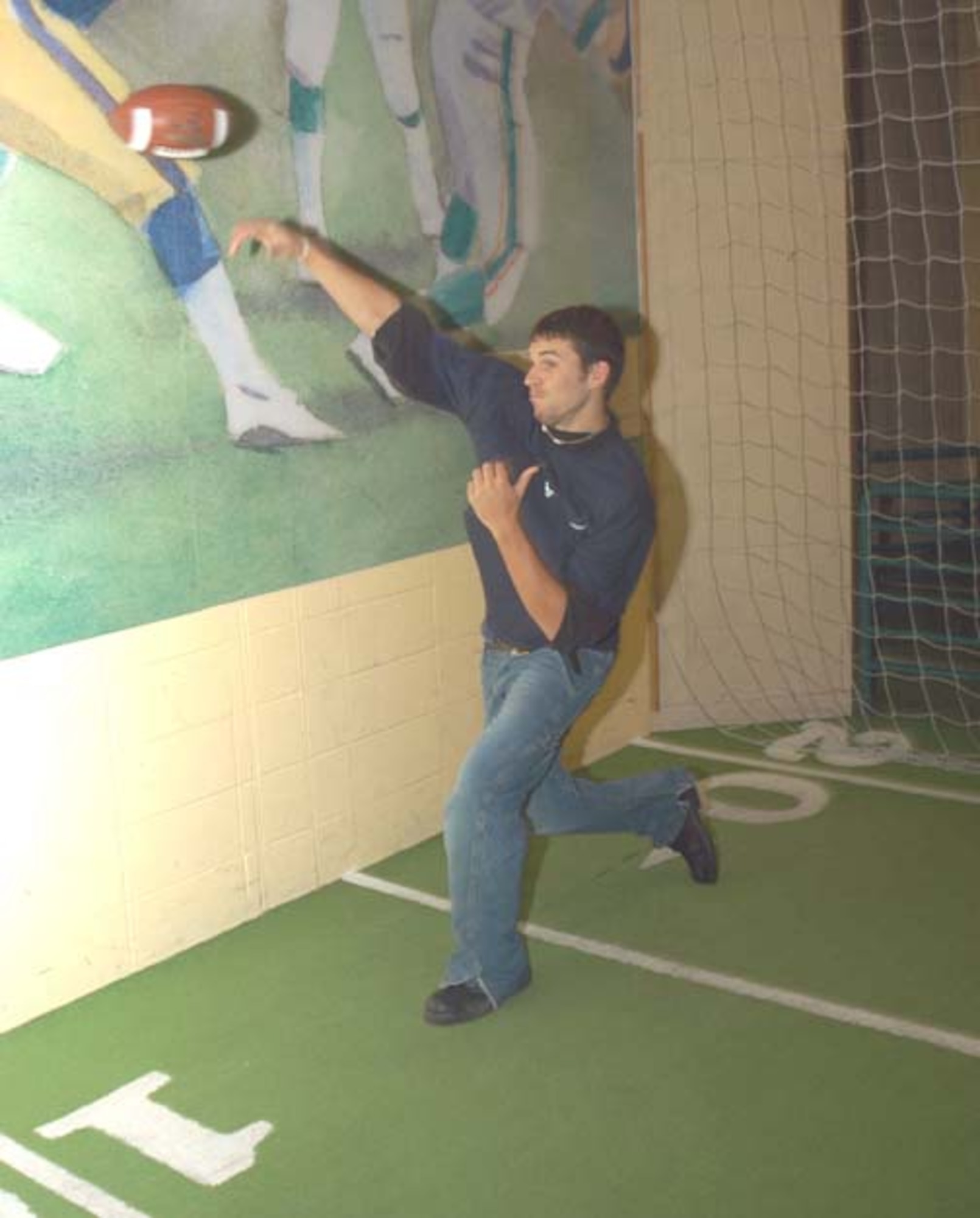 GRISSOM AIR RESERVE BASE, Ind -- Doug Cox, who enlisted into the Air Force Reserve on Oct. 19, throws a football at the College Football Hall of Fame in South Bend, Ind. The enlistment ceremony was held in front of family and friends at the hall of fame, which is the half-way point between Grissom Air Reserve Base, Ind. and General Mitchell Air Reserve Station, Wisc.  Cox joined the Air Force Reserve to gain experience he believes will help him in his pursuit to becoming a law enforcement officer. (U.S. Air Force photo\Senior Airman Mark Orders-Woempner)