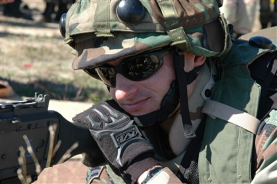 U.S. Air Force Airman 1st Class Travis Fillman watches over an entry control point with an M-60 machine gun during a training exercise on Naval Air Engineering Station Lakehurst, N.J., Oct. 13, 2006. Fillman is a security forces journeyman from the 817th Contingency Response Group, McGuire Air Force Base, N.J. 