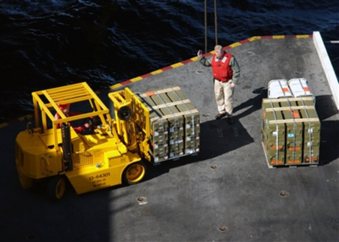U.S. Navy aviation ordnancemen load ordnance onto an aircraft elevator aboard the USS Theodore Roosevelt  in preparation for an ammunition offload, Oct. 21, 2006.